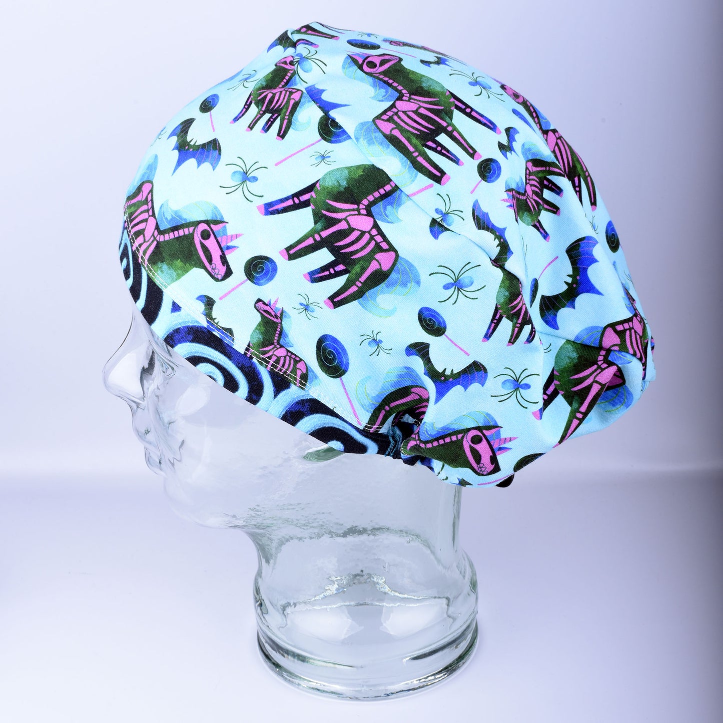Side profile of unicorn skeleton scrub cap highlighting comfortable hair coverage and soft stretch knit fabric.