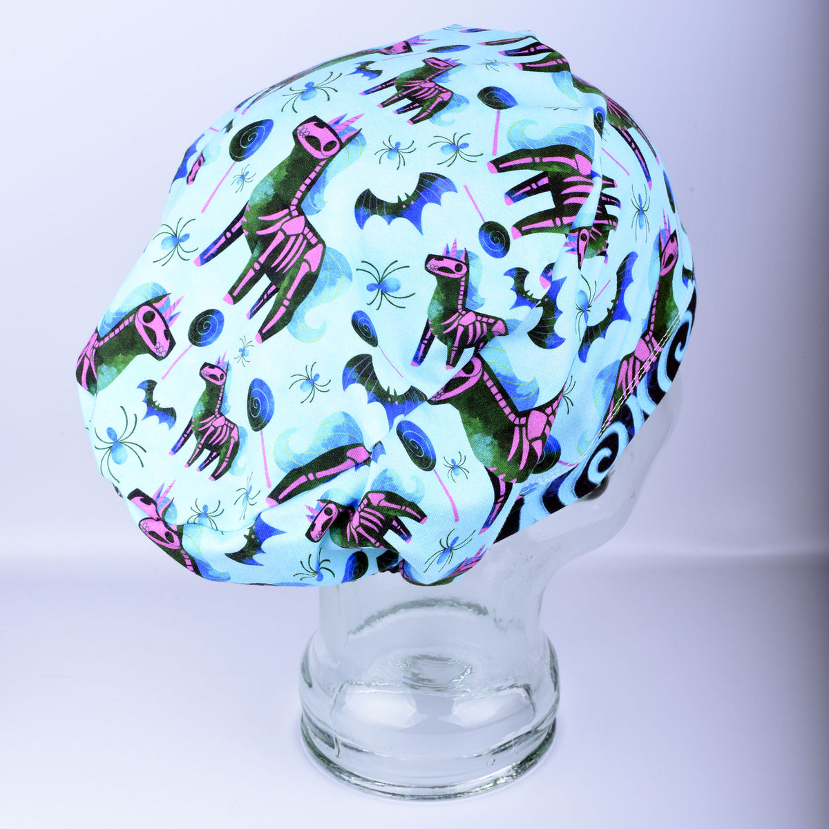Side profile of unicorn skeleton scrub cap highlighting comfortable hair coverage and soft stretch knit fabric.