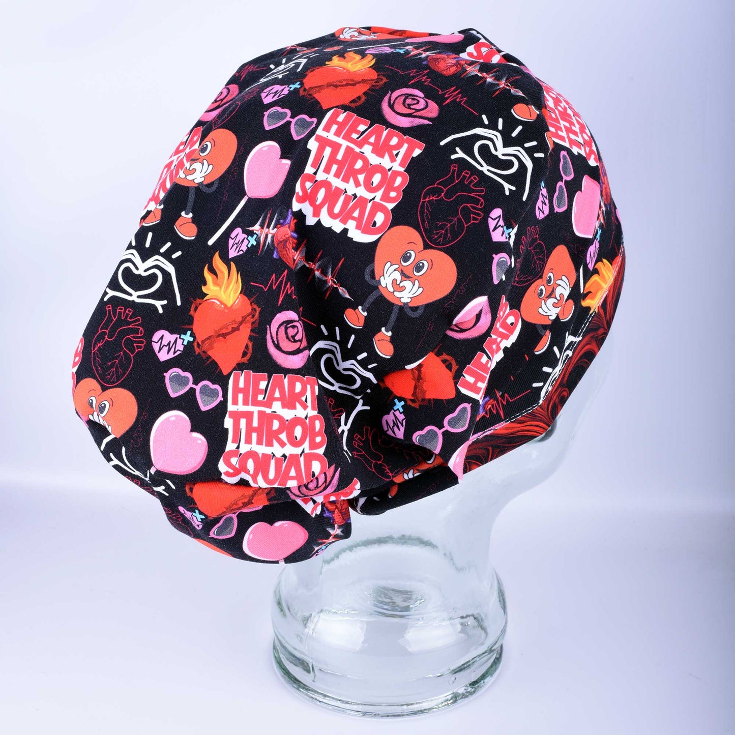 Side view of the Heart Throb Squad Scrub Cap showing the deep, full-coverage fit and stretchy cotton fabric.