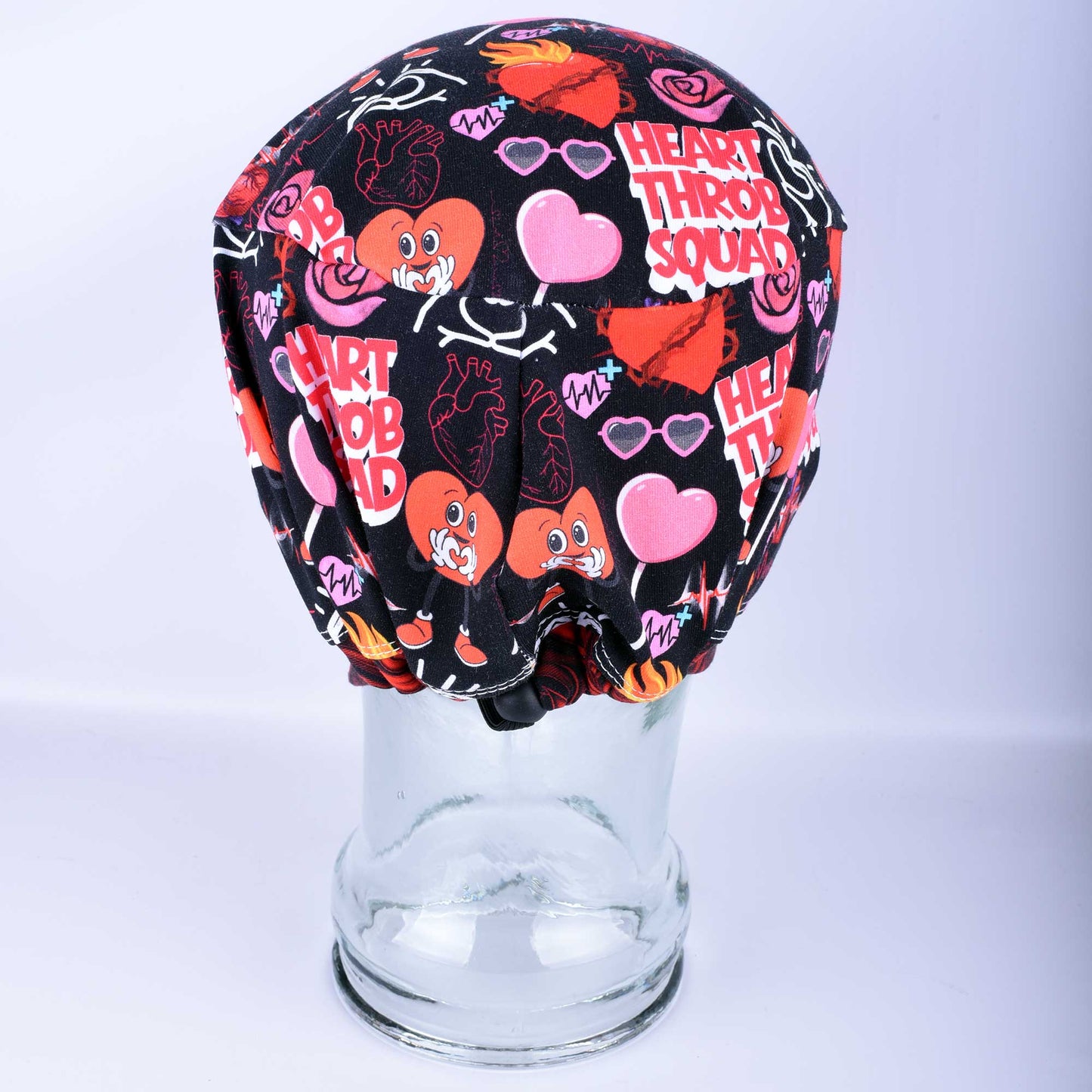 Back view of the Heart Throb Squad Scrub Cap highlighting the adjustable cord lock toggle and elastic back closure.