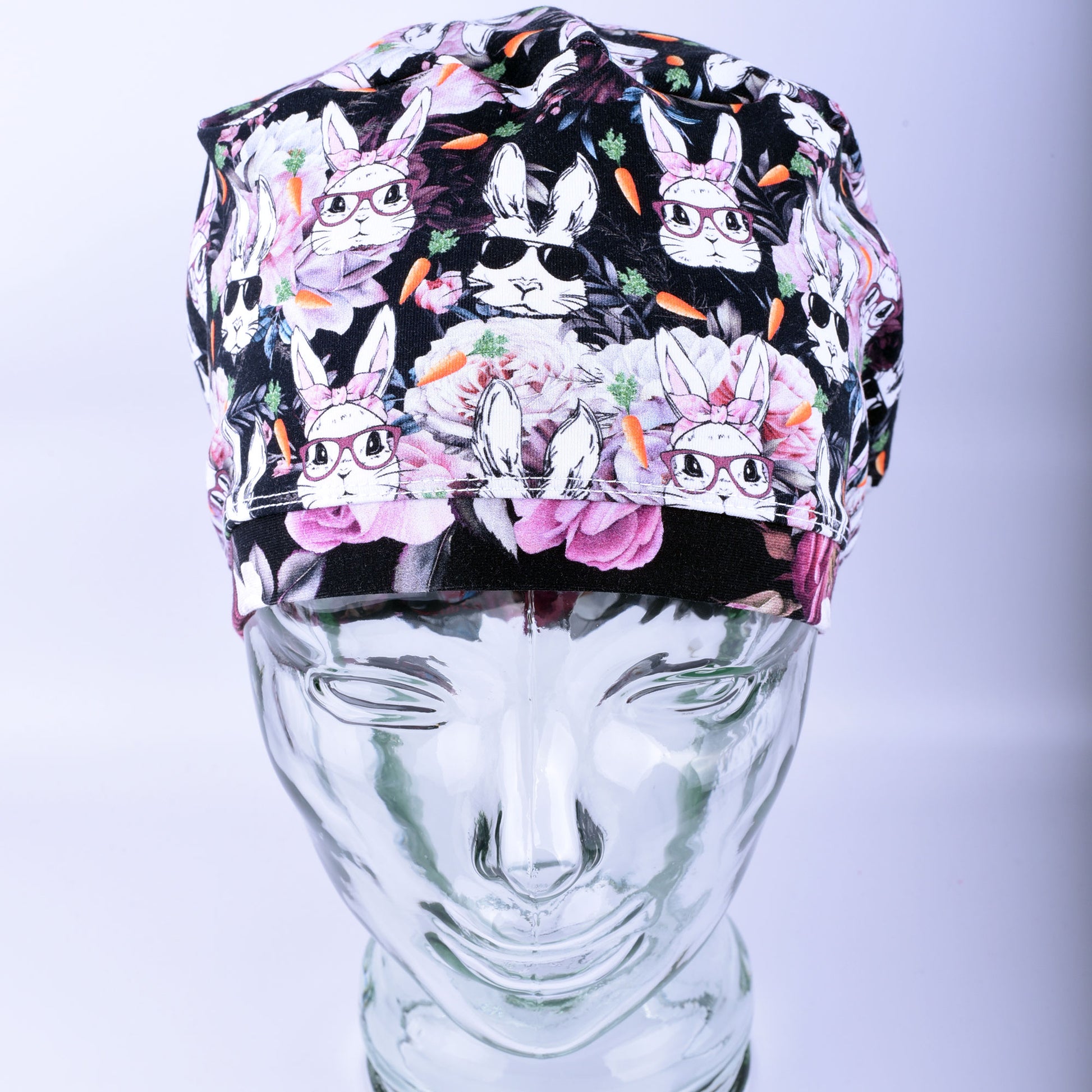 Colorful scrub hat with rabbit pattern on a mannequin head against a light gray background