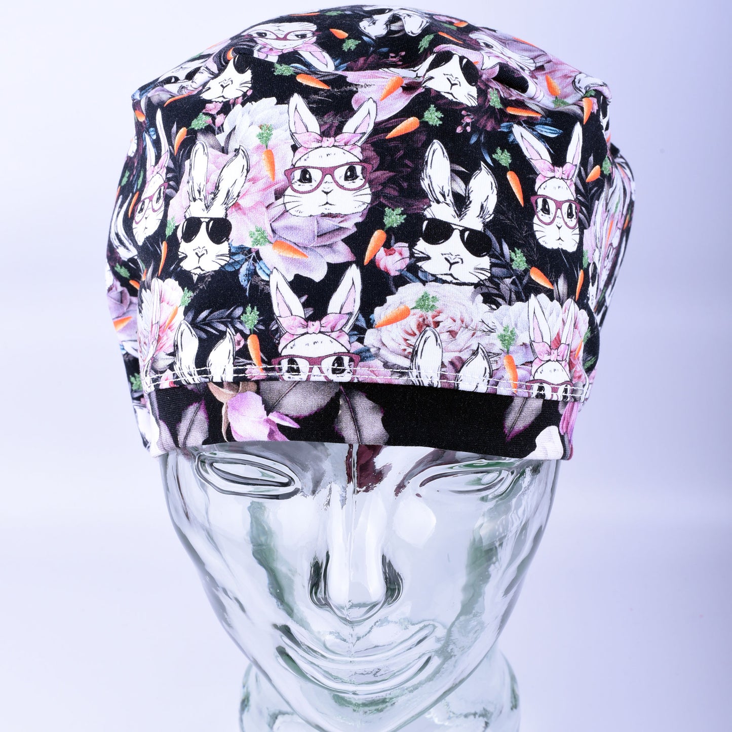 Surgical cap with rabbit pattern on a mannequin head against a white background