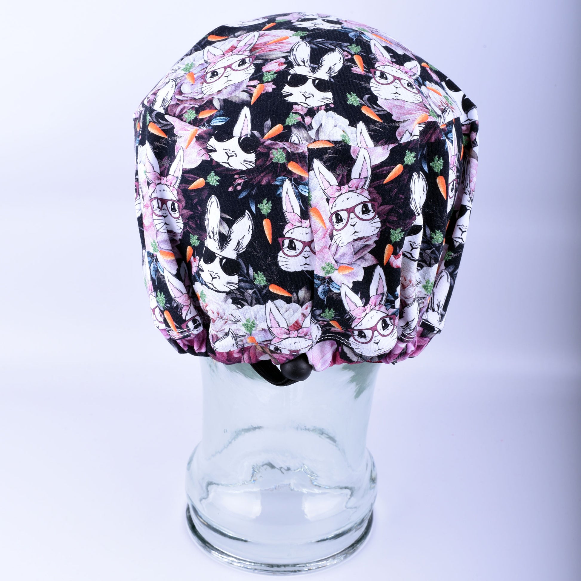 Back of a medical scrub cap featuring an adjustable cord lock toggle for a custom, secure fit.
