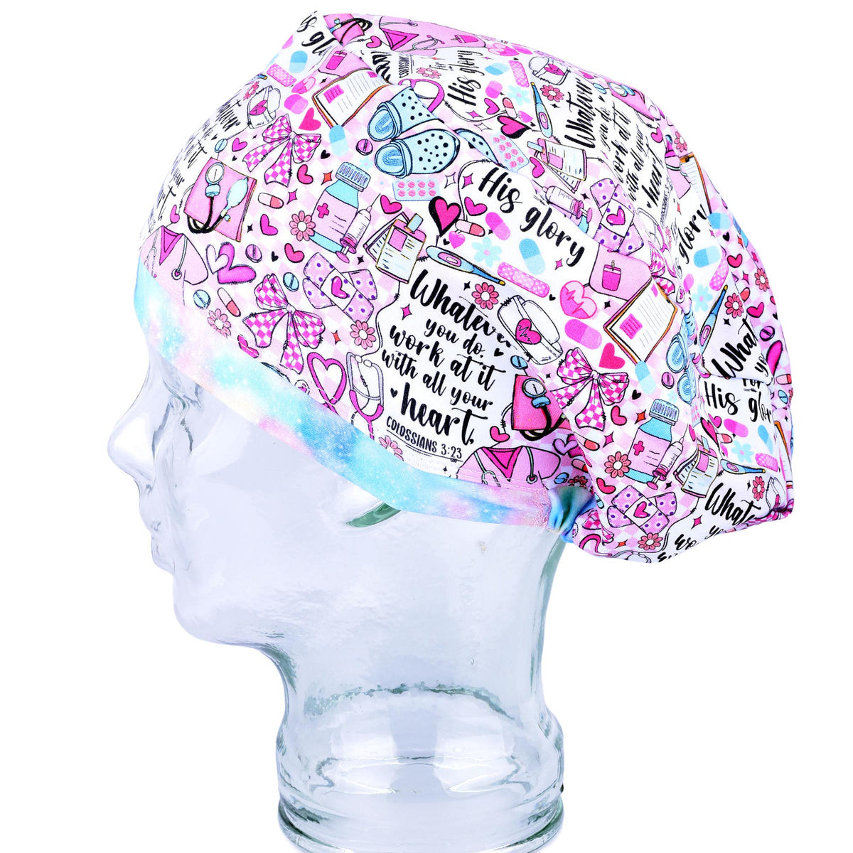 A pink and white patterned scrub cap with medical-themed illustrations and a Bible verse, displayed on a clear mannequin head against a white background.