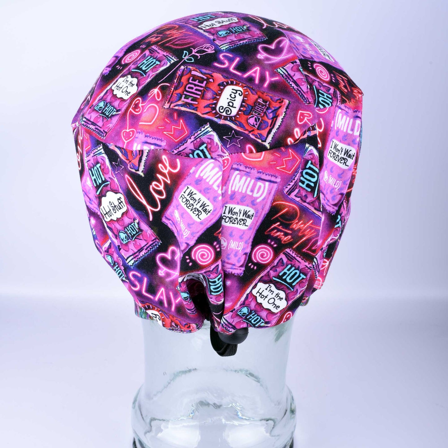 Full coverage Hot and Spicy Scrub Cap featuring a vibrant red chili pepper pattern on black fabric.