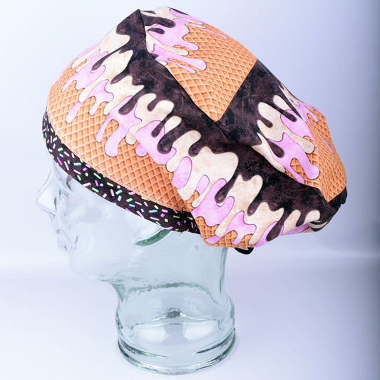 Melted ice cream print full coverage scrub cap with chocolate and vanilla swirls and rainbow sprinkles.