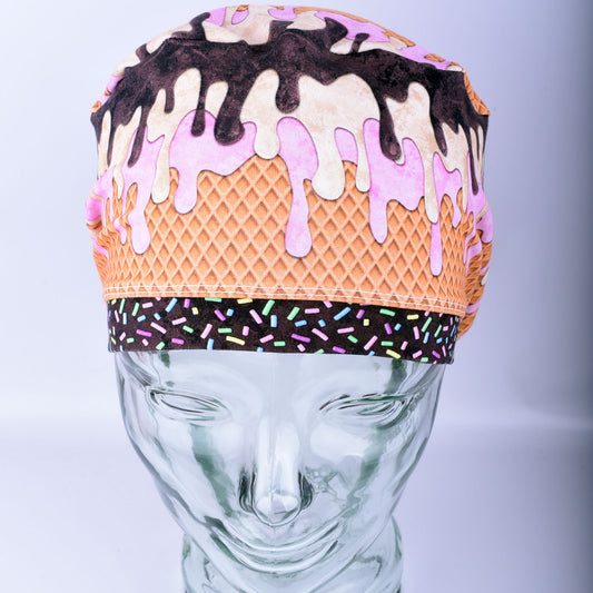Front view of a stretchy cotton surgical hat featuring a colorful melted ice cream pattern for healthcare professionals.