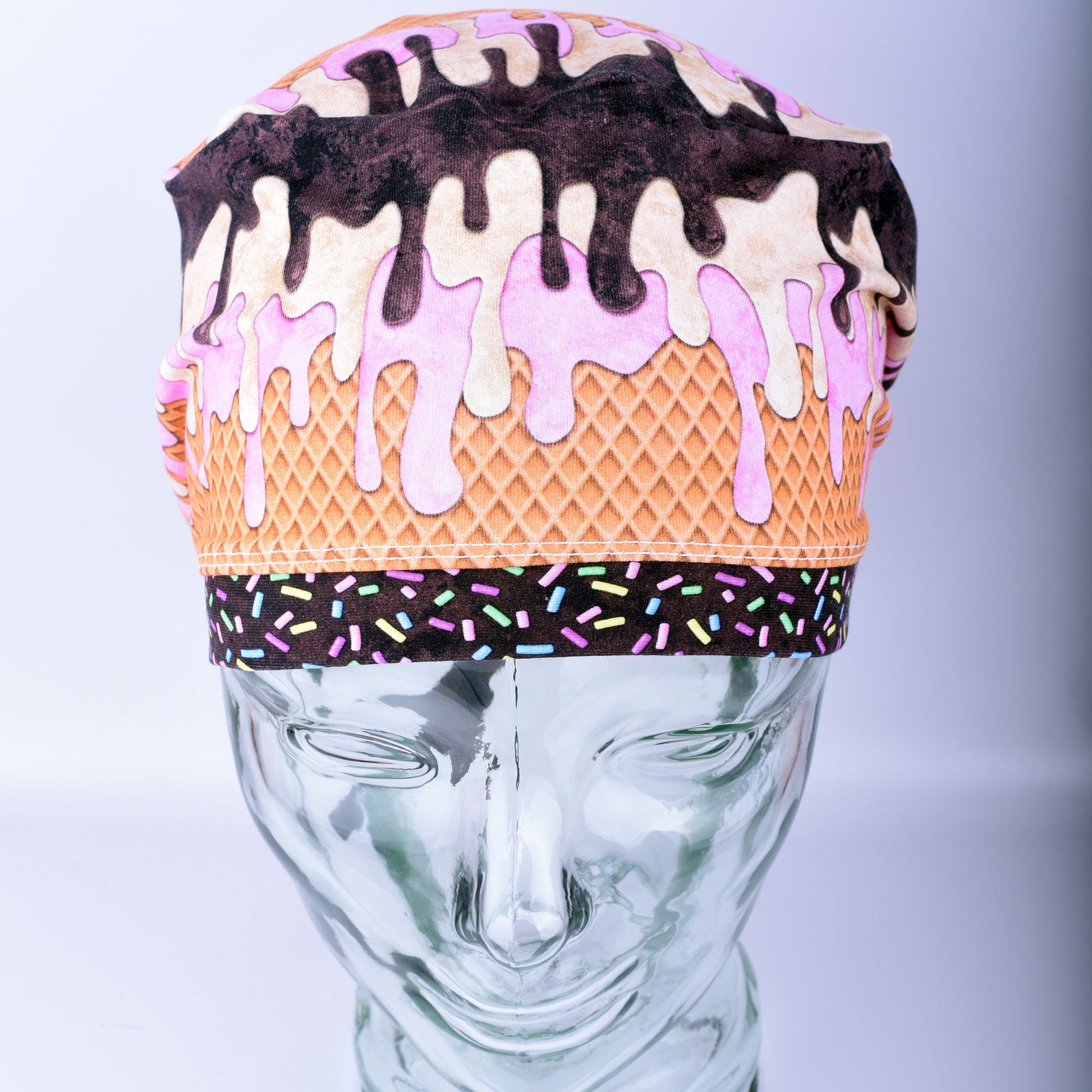 Front view of a stretchy cotton surgical hat featuring a colorful melted ice cream pattern for healthcare professionals.