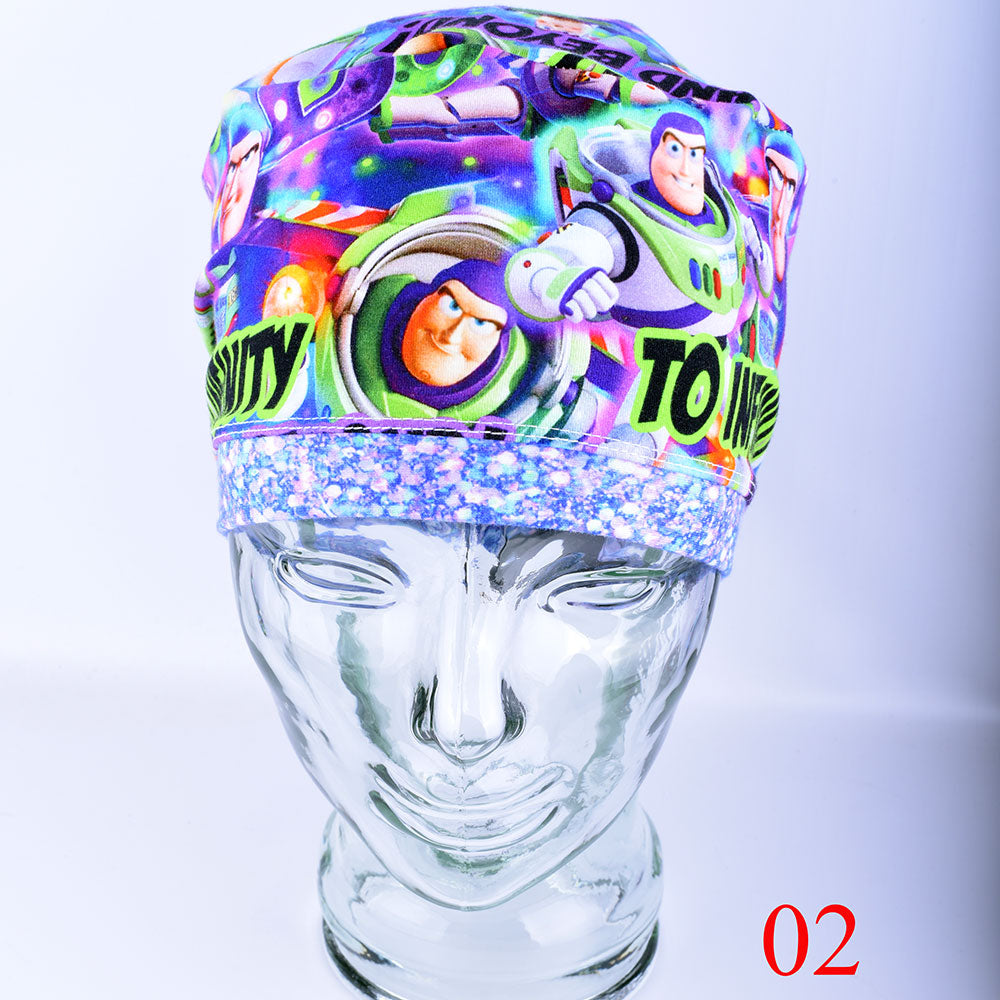 Front view of a full-coverage surgical scrub cap on a clear mannequin head, featuring a vibrant cartoon astronaut and outer space pattern on a crisp white background.