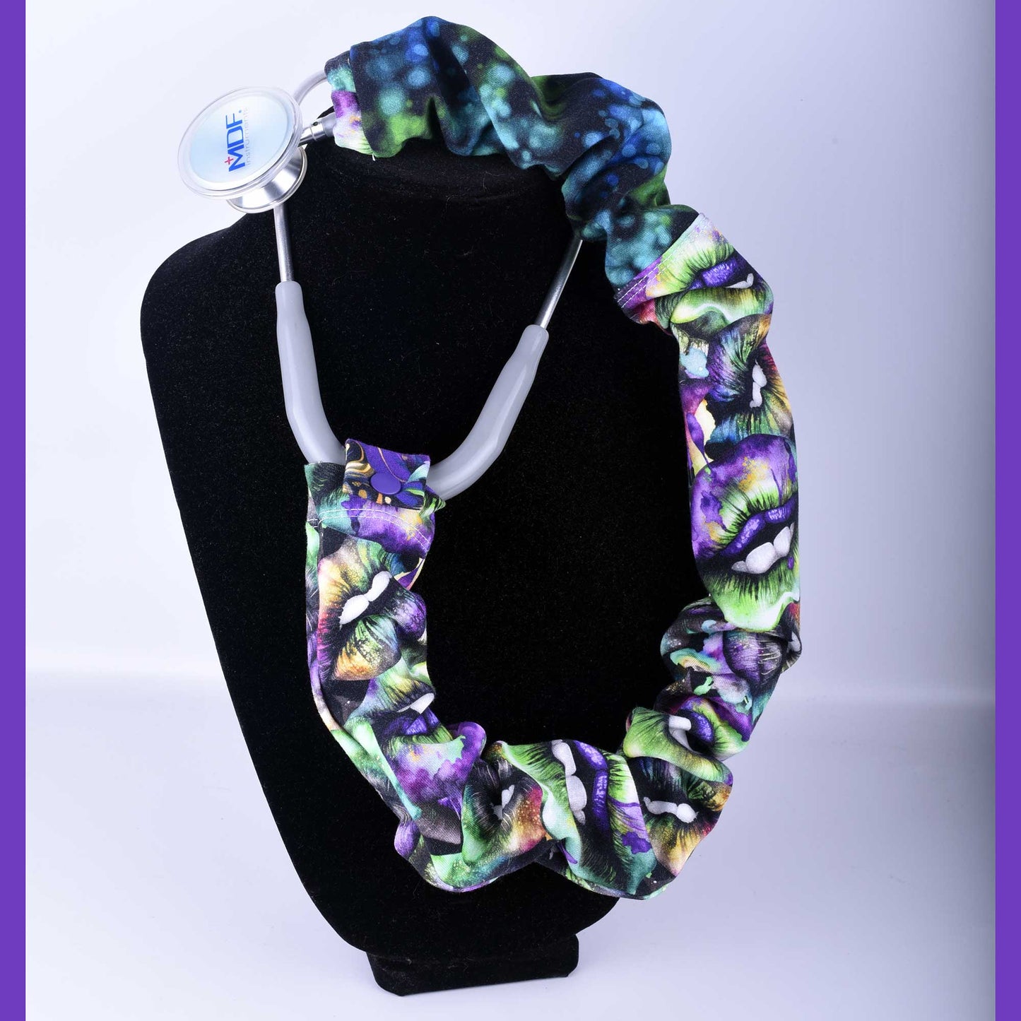 Lucky Lips pattern stethoscope cover made of stretchy cotton fabric, shown on a black stethoscope against a white background.