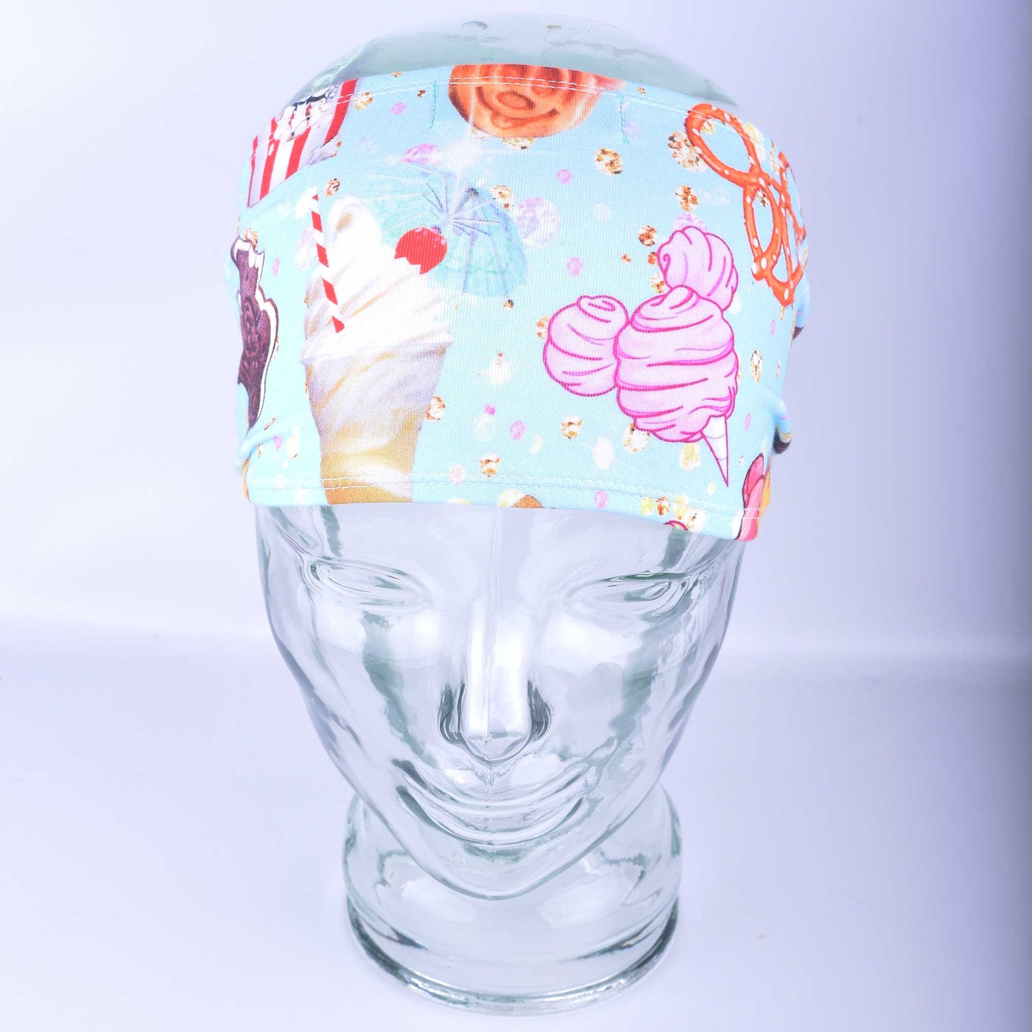 Magical Snacks wide headband featuring a colorful theme park treats print on a clear mannequin head.