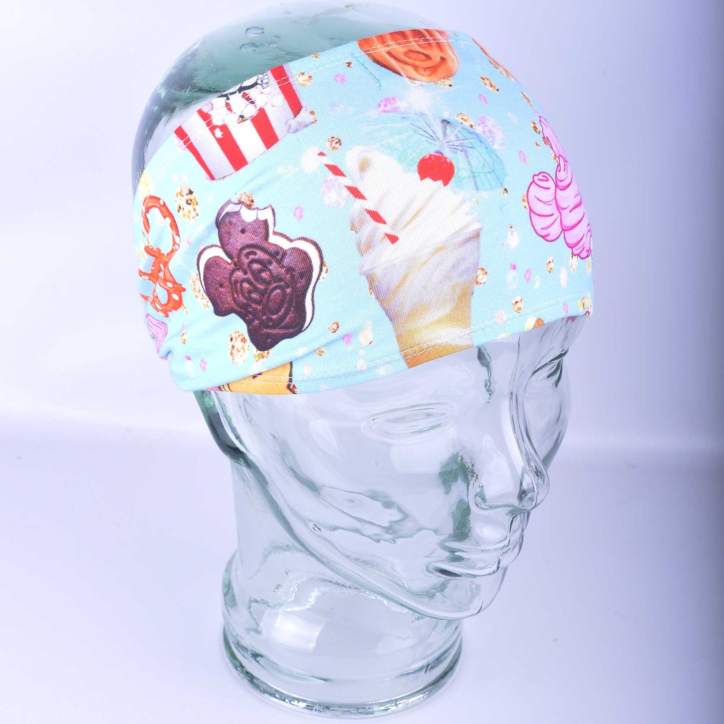 Side profile of the wide colorful snacks pattern hair band showcasing the comfortable ear coverage.