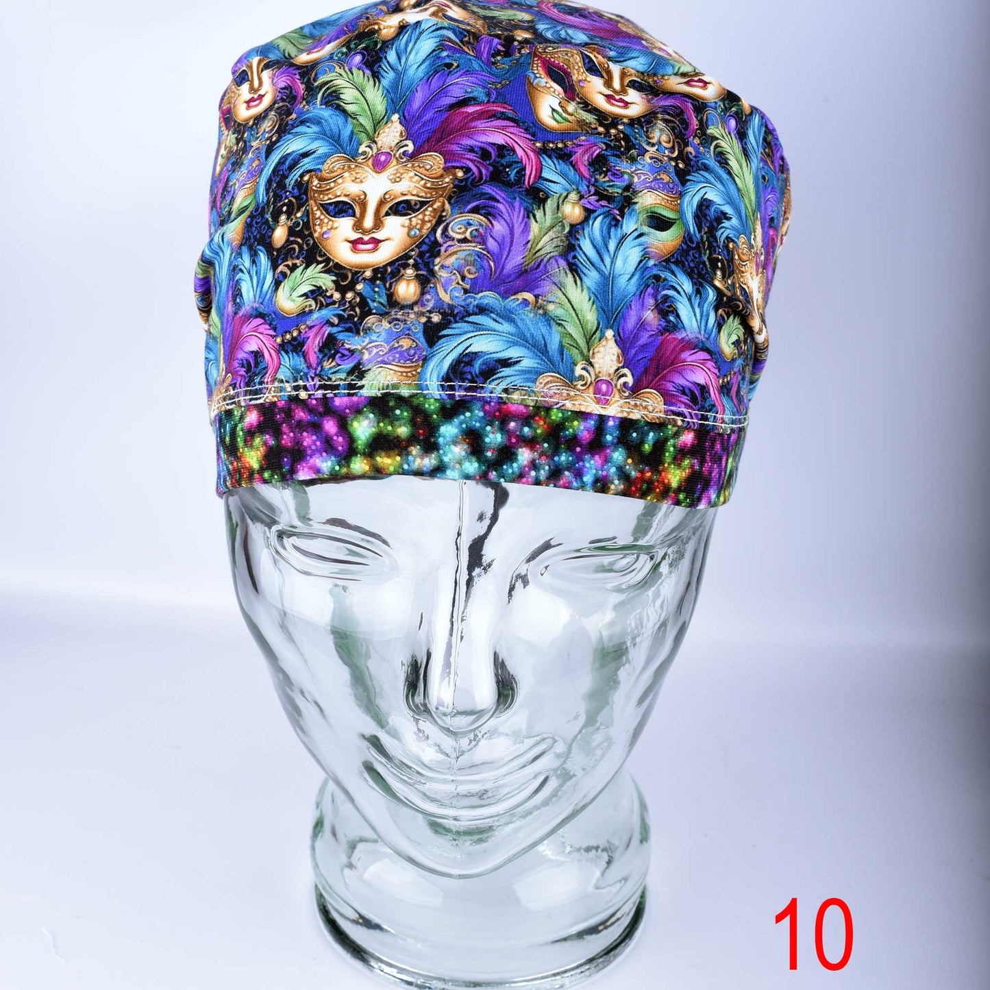 Handmade full coverage scrub hat for medical professionals featuring exclusive Mardi Gras mask art.