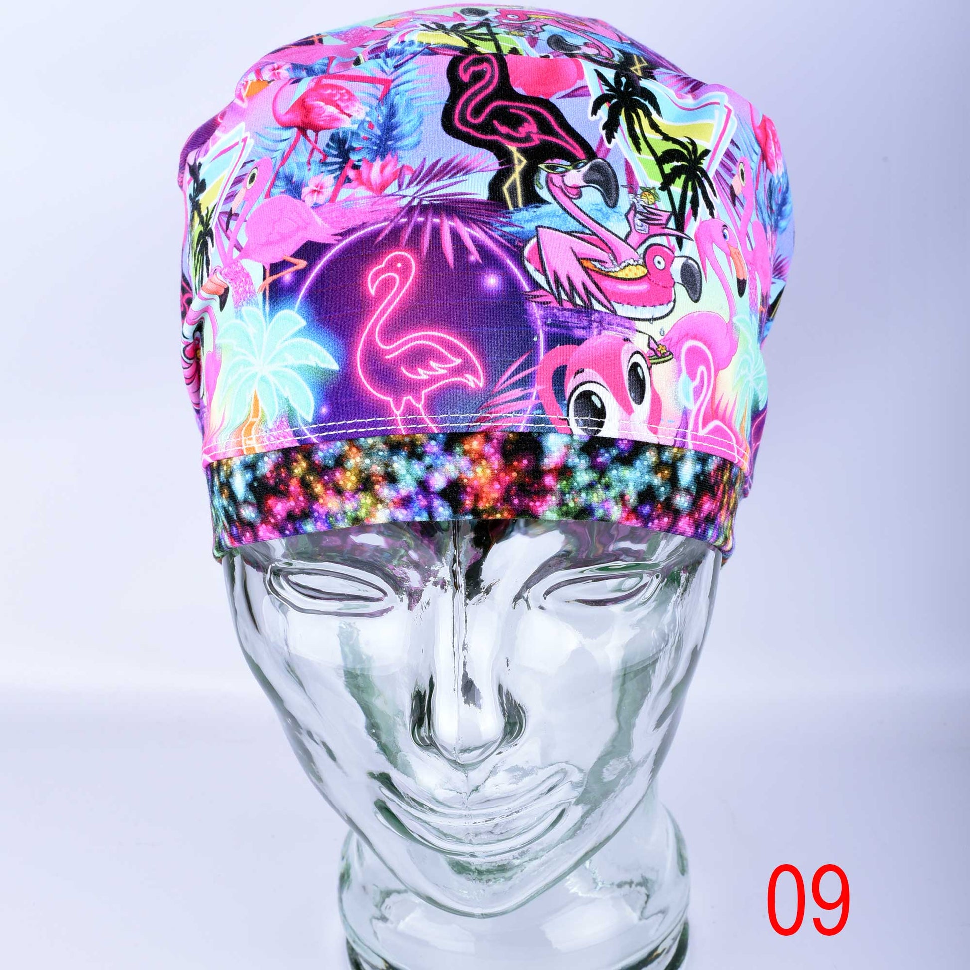 Handmade full coverage scrub cap featuring a vibrant neon pink flamingo and tropical floral print on a blue background.