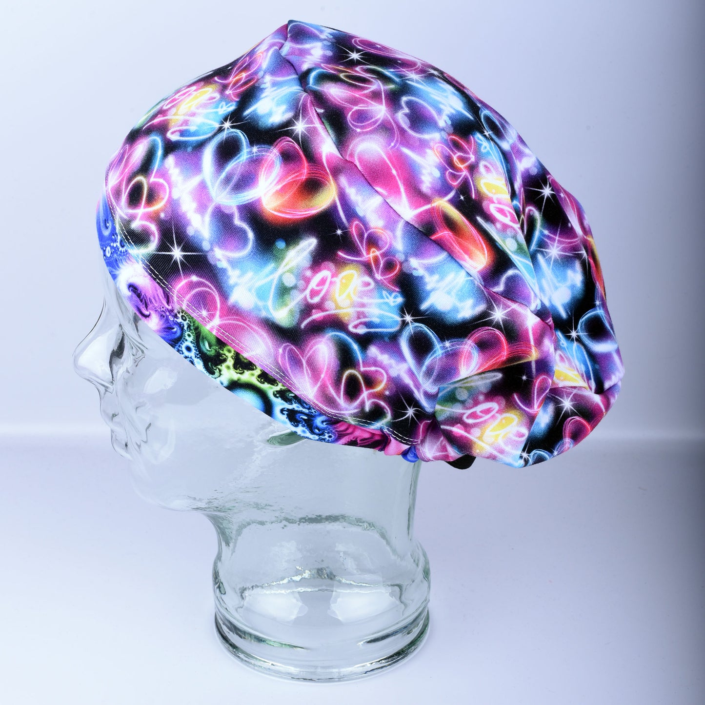 Neon Hearts Scrub Cap for medical professionals featuring a vibrant multicolor heart print on a black background