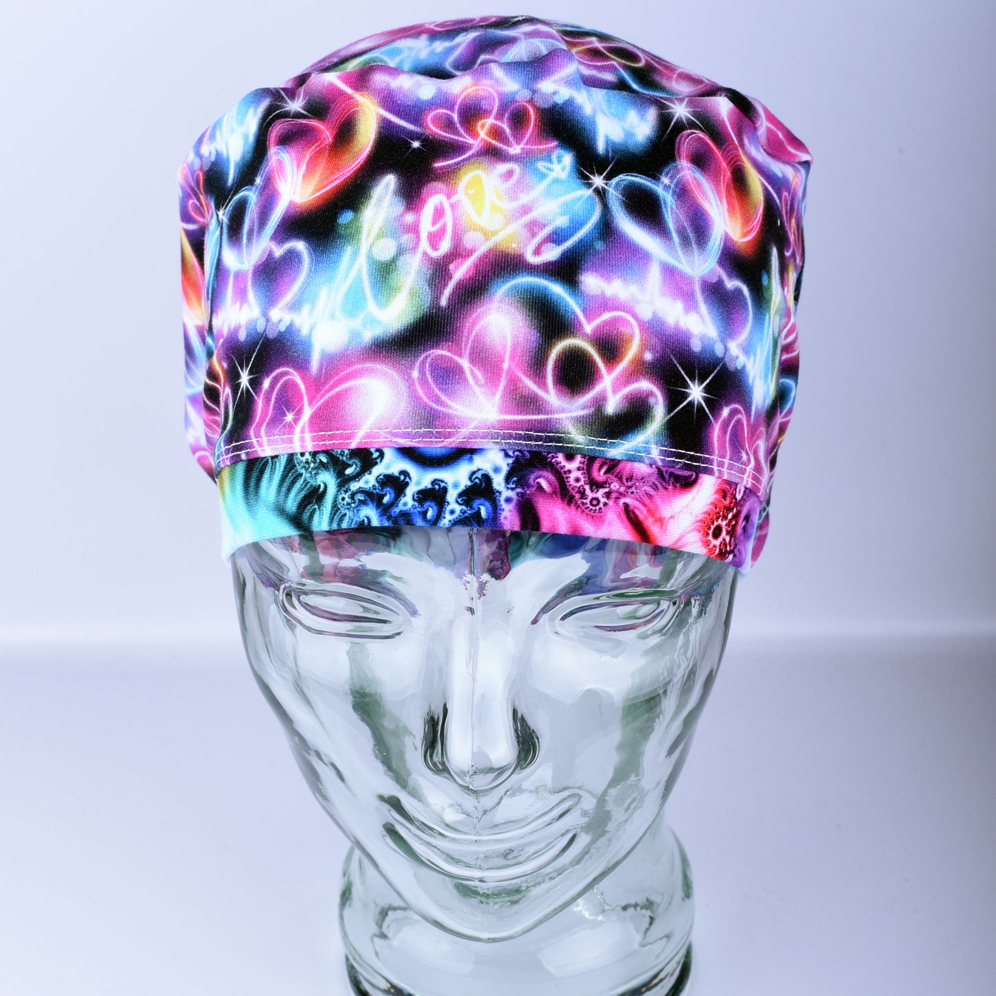 Neon Hearts Scrub Cap for medical professionals featuring a vibrant multicolor heart print on a black background