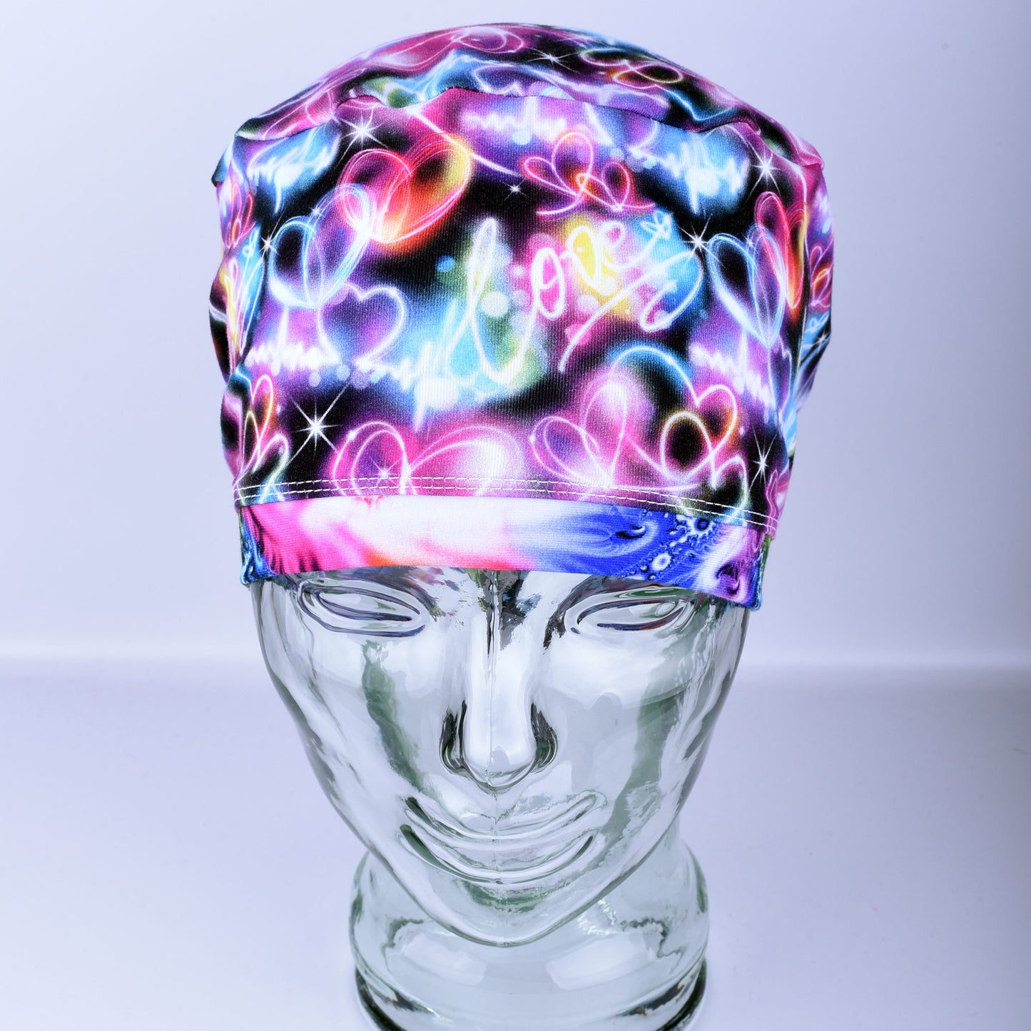 Neon Hearts Scrub Cap for medical professionals featuring a vibrant multicolor heart print on a black background