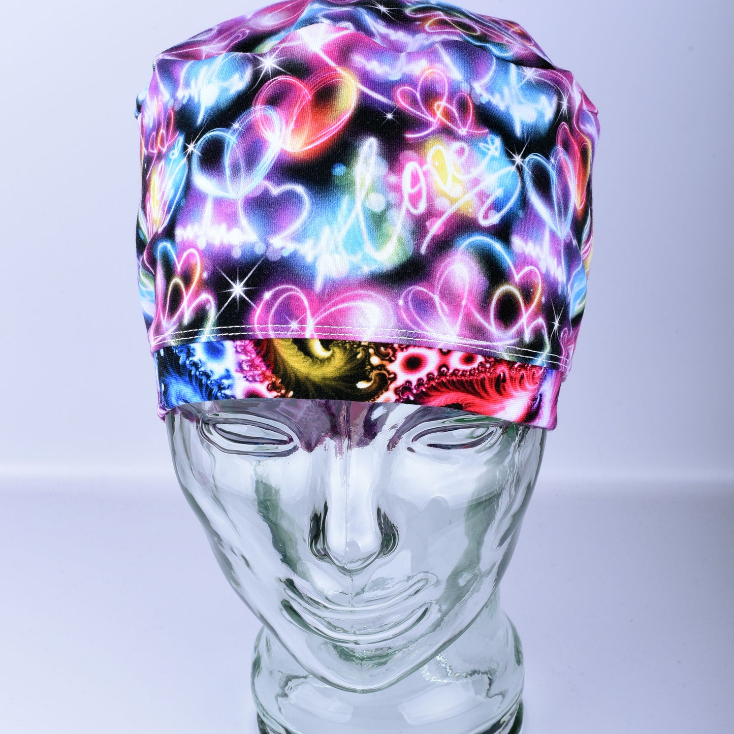 Neon Hearts Scrub Cap for medical professionals featuring a vibrant multicolor heart print on a black background.