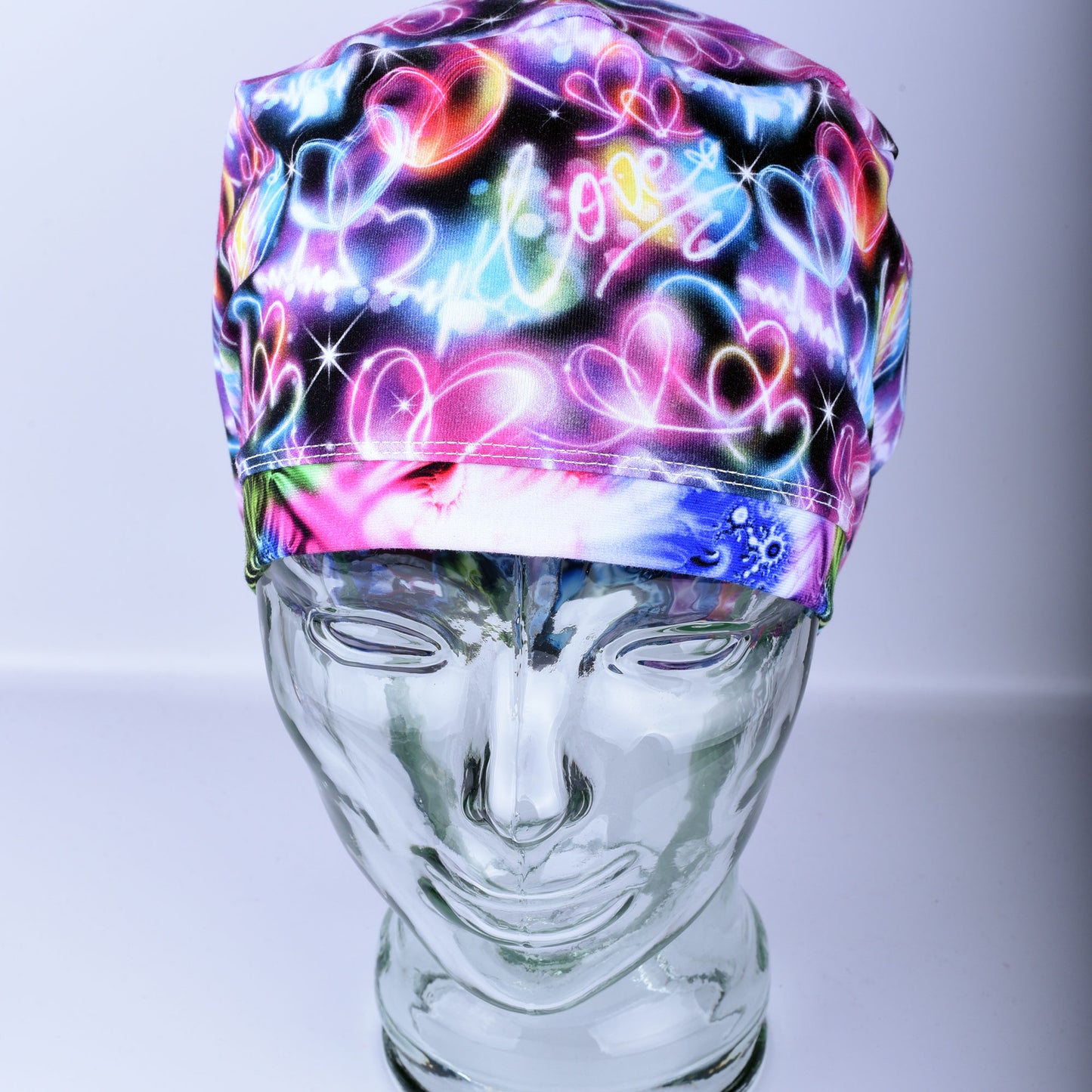 Neon Hearts Scrub Cap for medical professionals featuring a vibrant multicolor heart print on a black background
