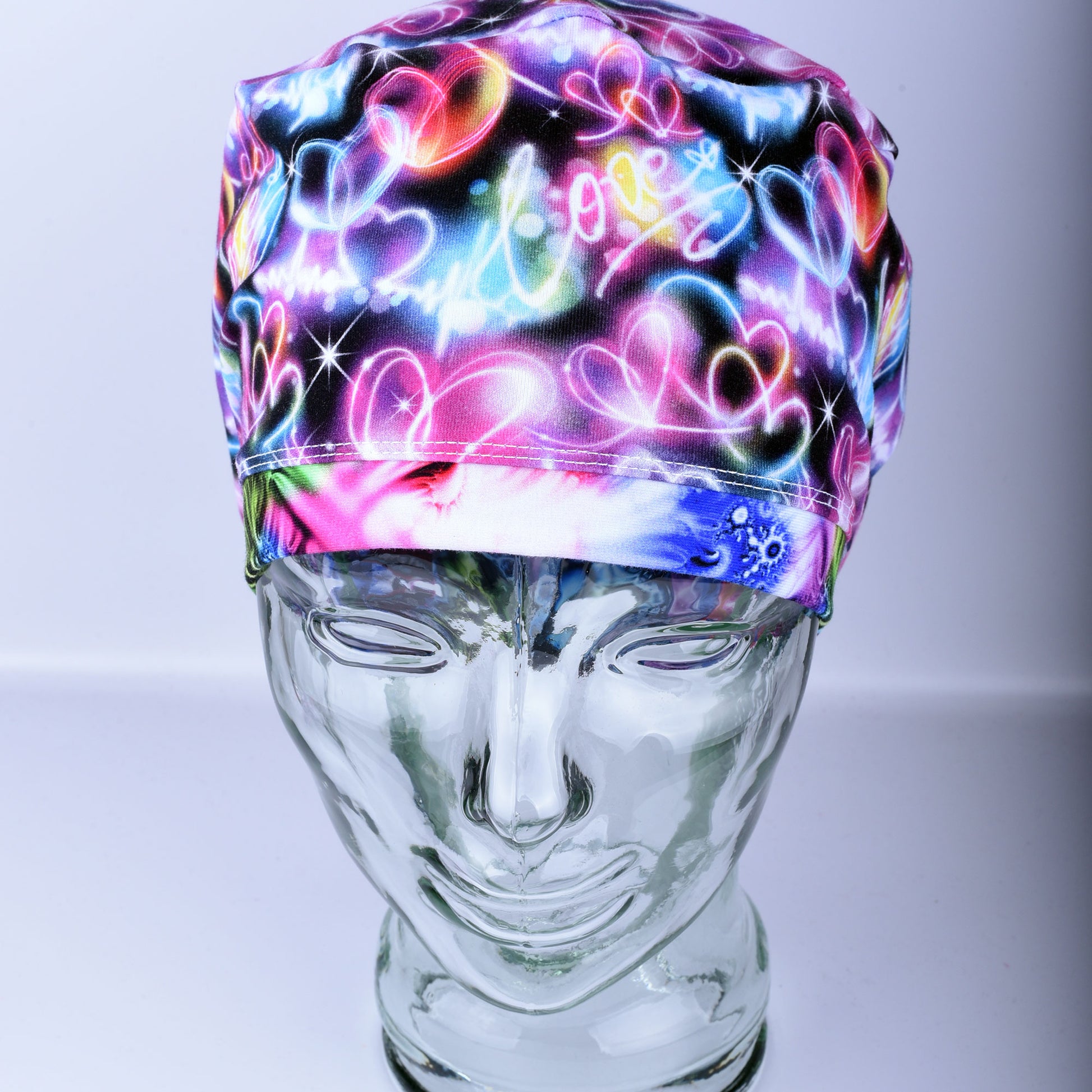 Neon Hearts Scrub Cap for medical professionals featuring a vibrant multicolor heart print on a black background
