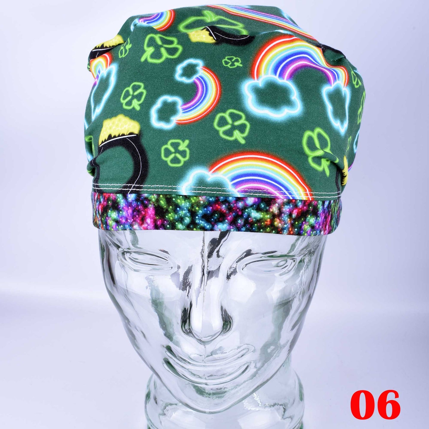 Full coverage neon St. Patrick's Day scrub cap with vibrant green and white clover patterns on a black background.
