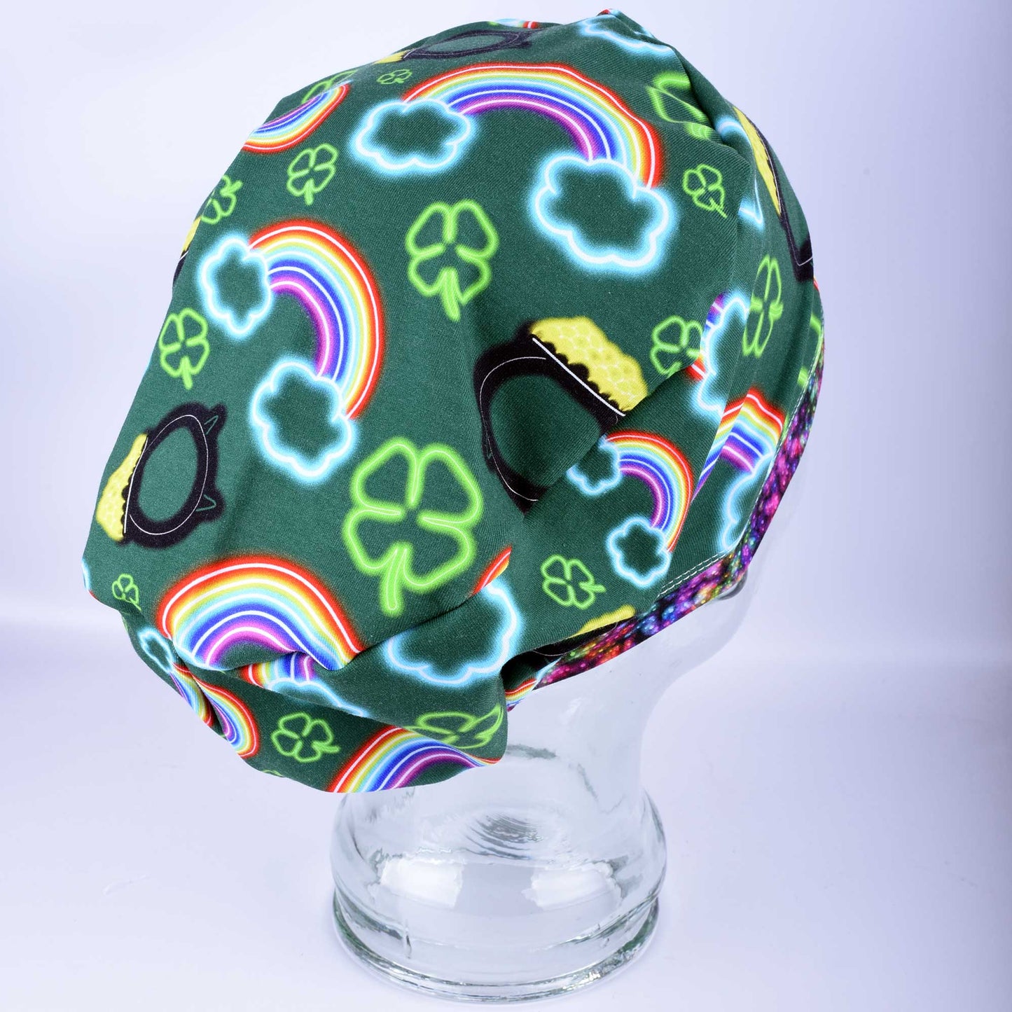 Full coverage neon St. Patrick's Day scrub cap with vibrant green and white clover patterns on a black background.