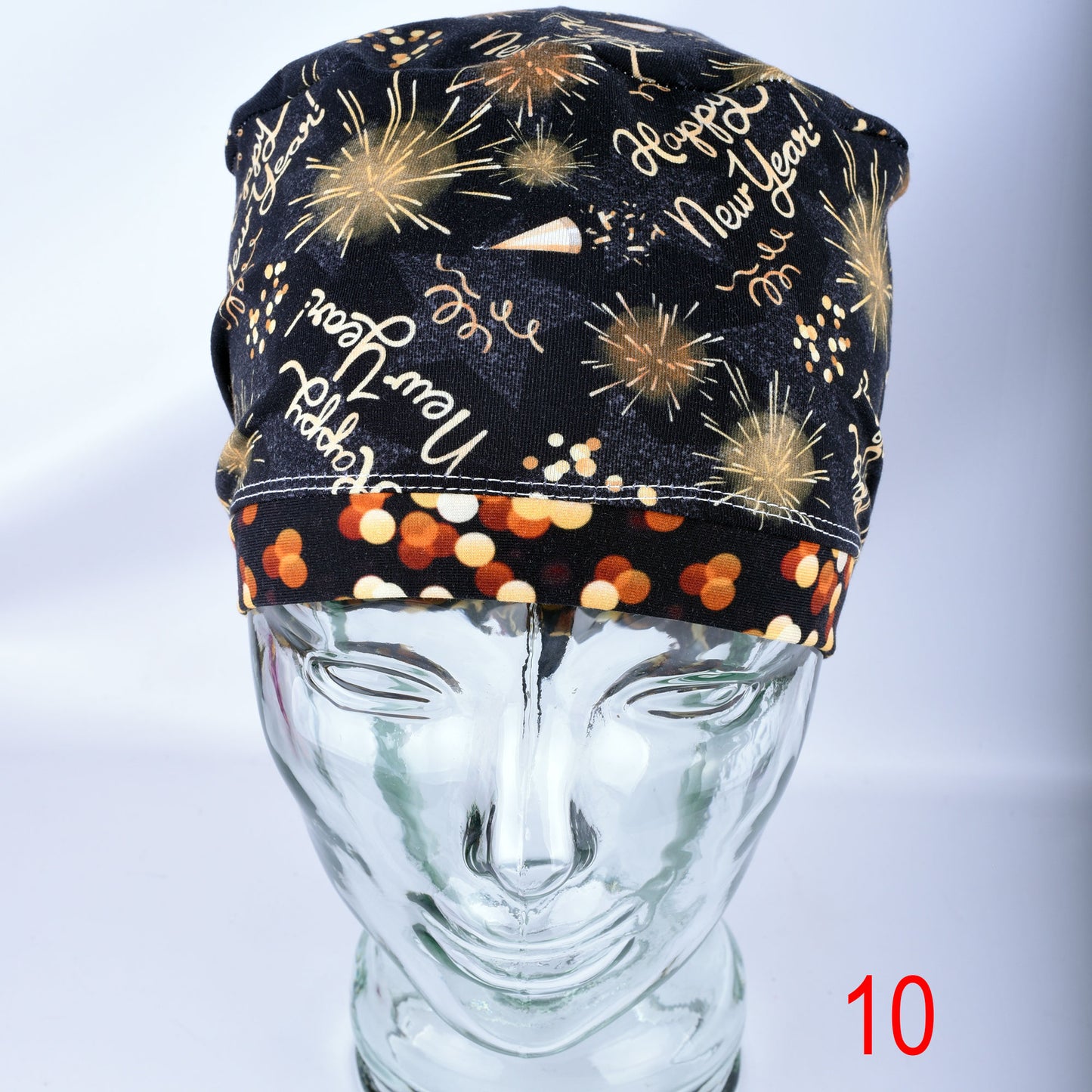 Front view of the New Year Celebration scrub cap showing full-coverage fit and colorful party graphics.