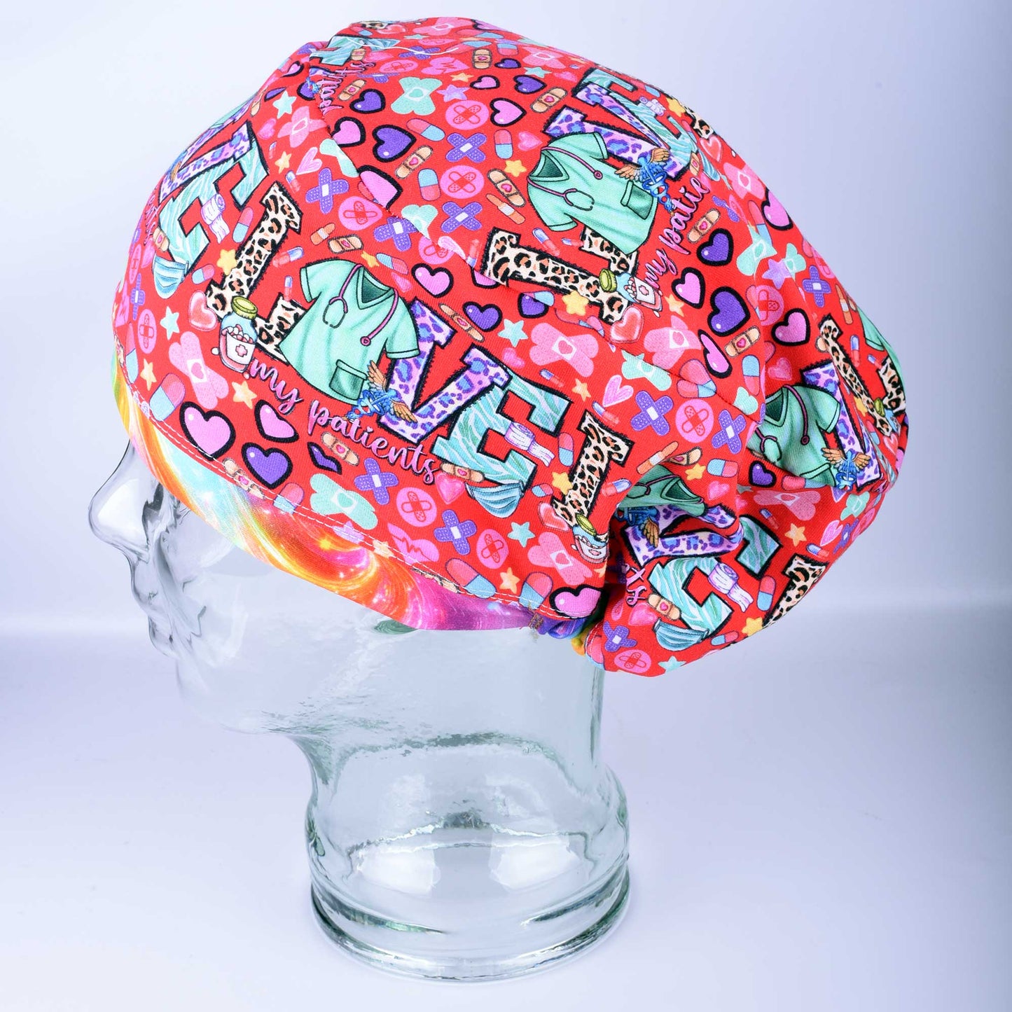Patient Love Heart Print Scrub Cap for nurses and doctors featuring a vibrant multicolor heart pattern on a white background