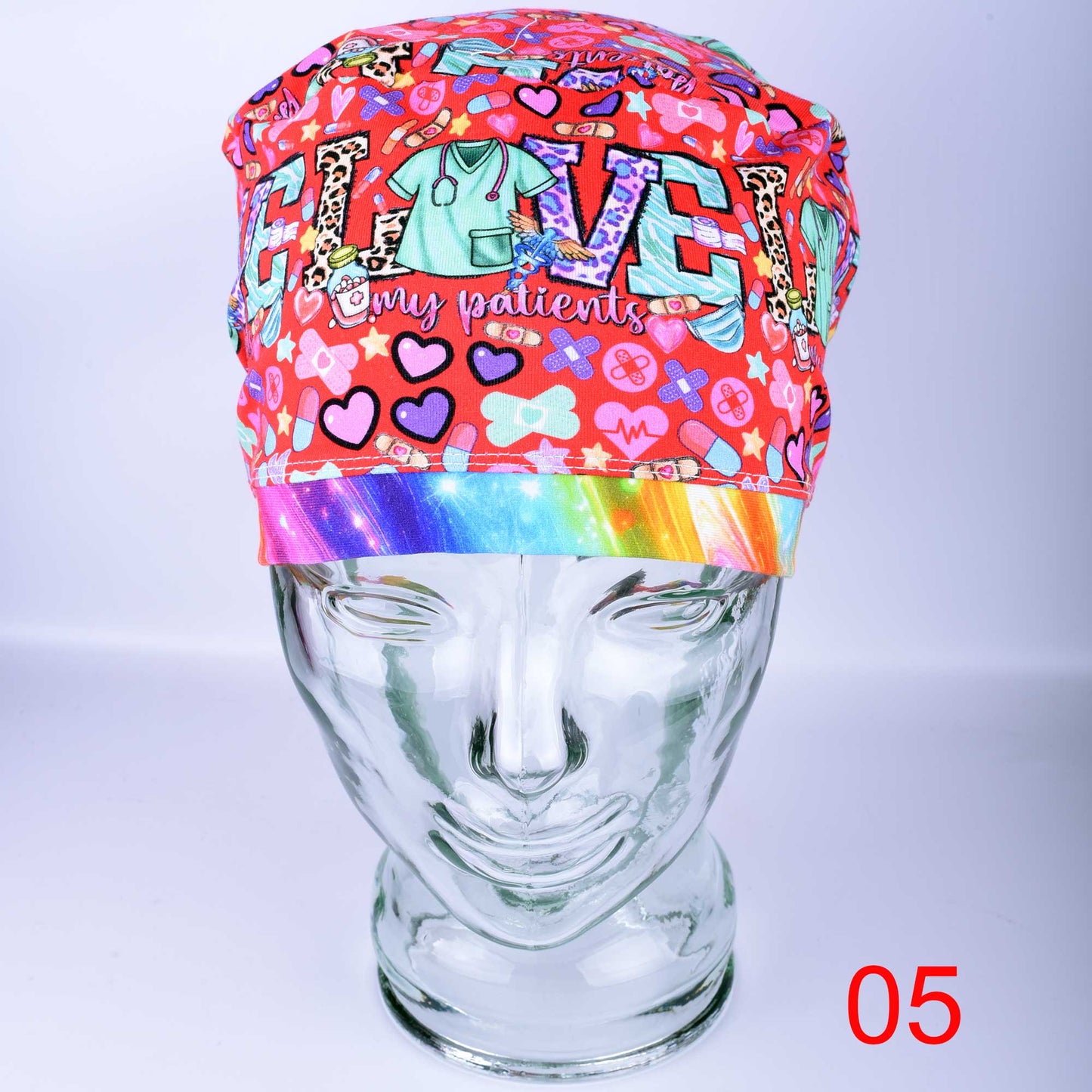 Euro style scrub hat with custom Patient Love heart design in pink, red, and blue with adjustable cord lock for a secure fit.