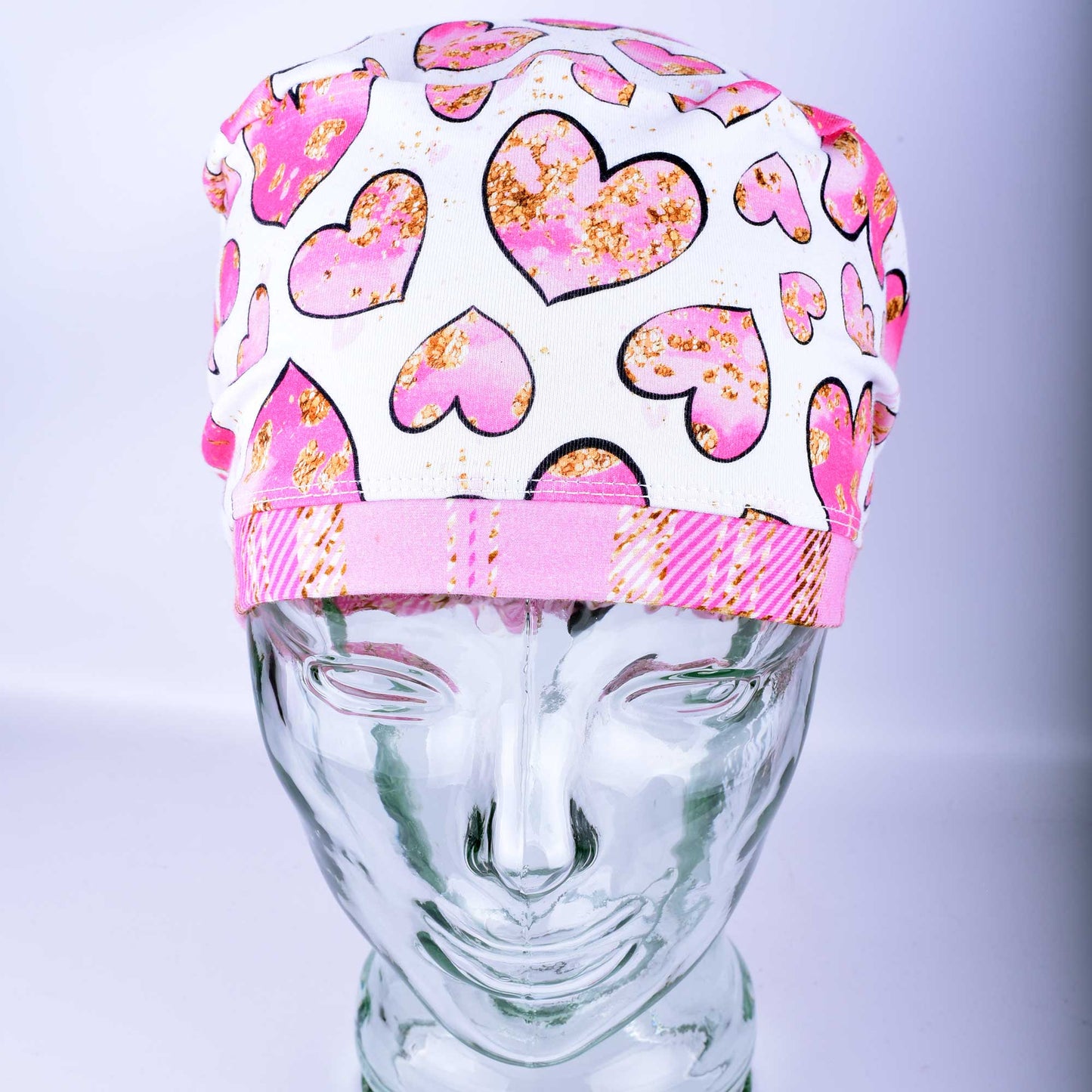 Pink Gold Hearts Scrub Cap featuring hand-drawn pink and gold hearts on a stretchy white knit fabric.