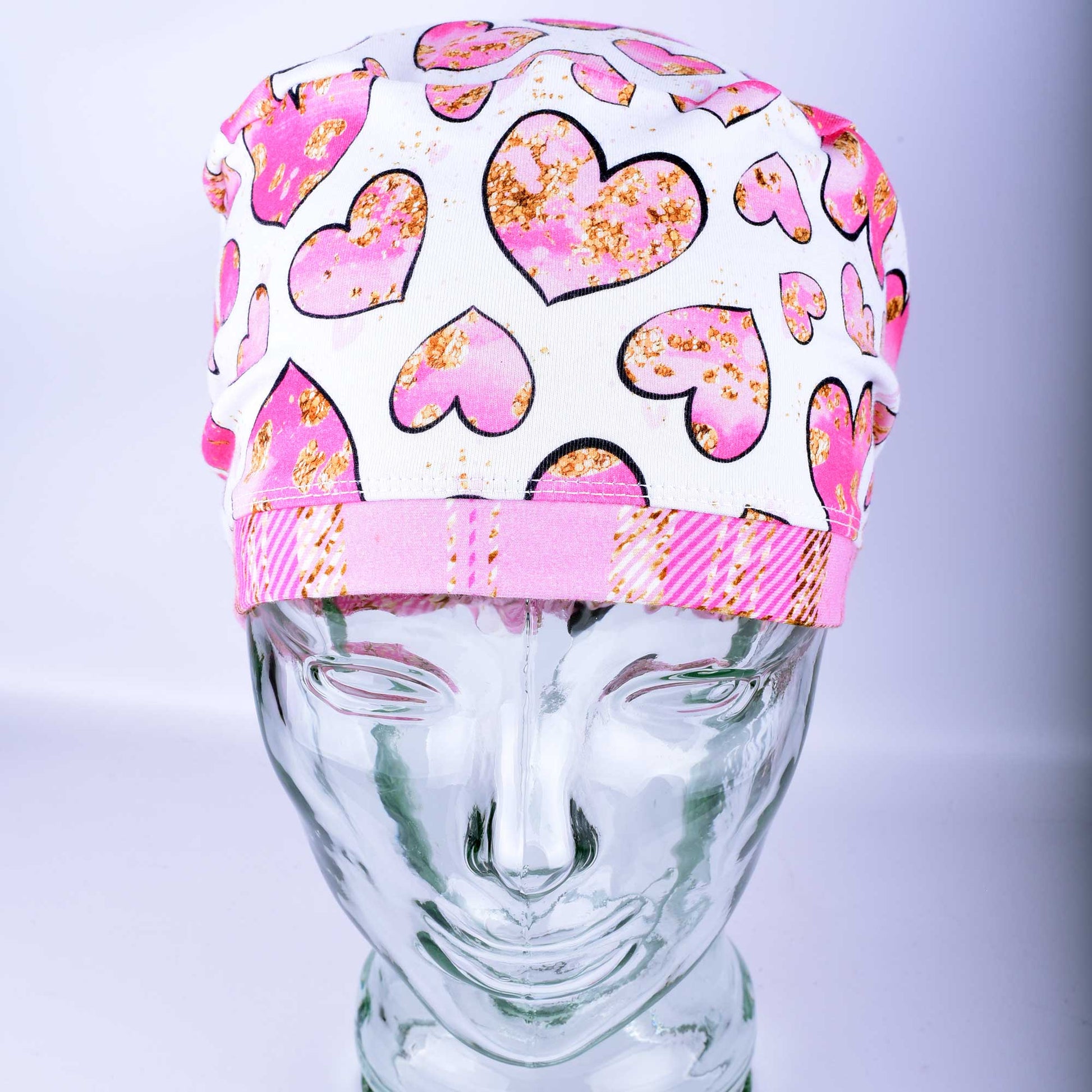 Pink Gold Hearts Scrub Cap featuring hand-drawn pink and gold hearts on a stretchy white knit fabric.