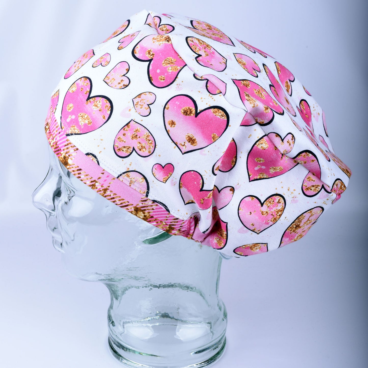 Pink Gold Hearts Scrub Cap featuring hand-drawn pink and gold hearts on a stretchy white knit fabric.