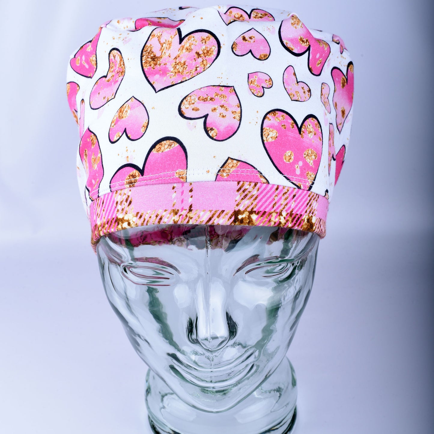 Pink Gold Hearts Scrub Cap featuring hand-drawn pink and gold hearts on a stretchy white knit fabric.