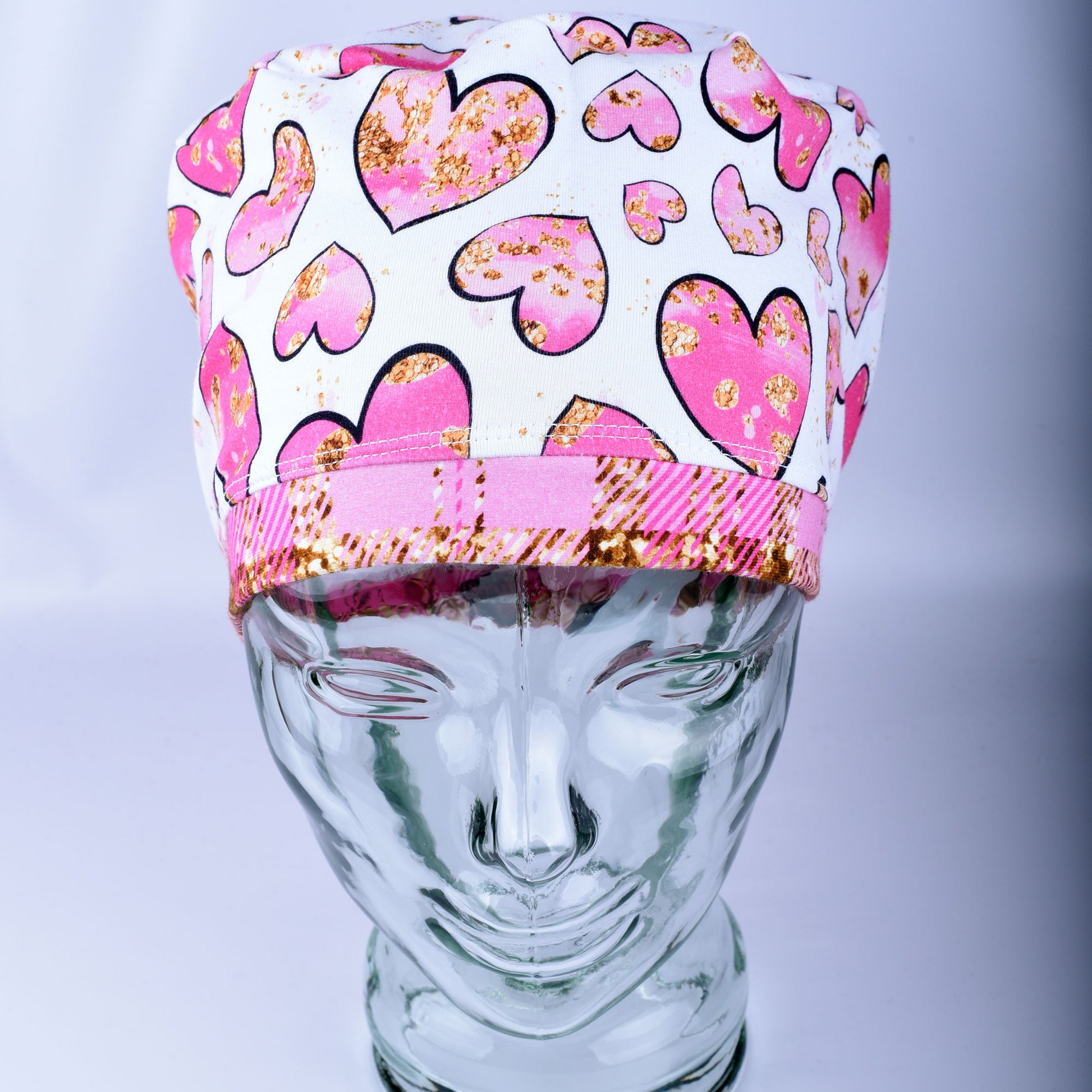 Pink Gold Hearts Scrub Cap featuring hand-drawn pink and gold hearts on a stretchy white knit fabric.