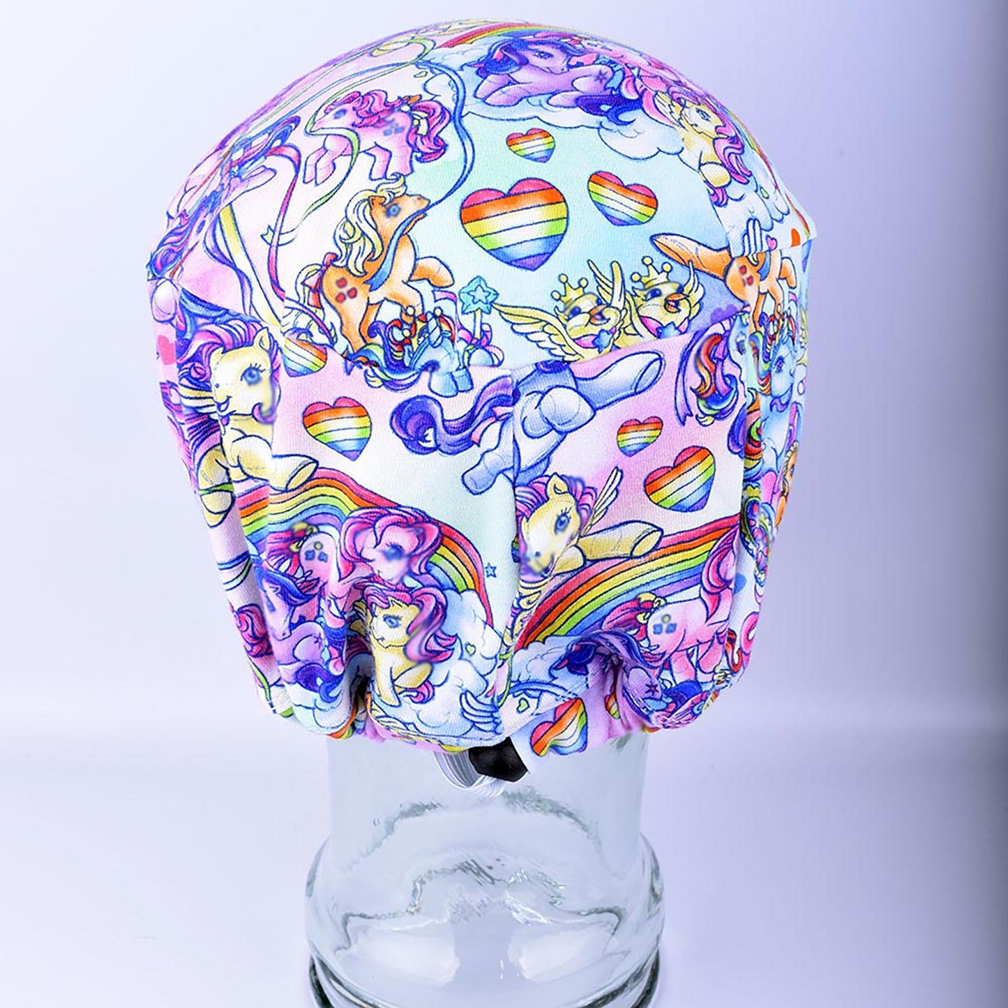 Rear view of the rainbow pony scrub hat highlighting the adjustable black cord lock toggle and encased elastic for a custom fit.