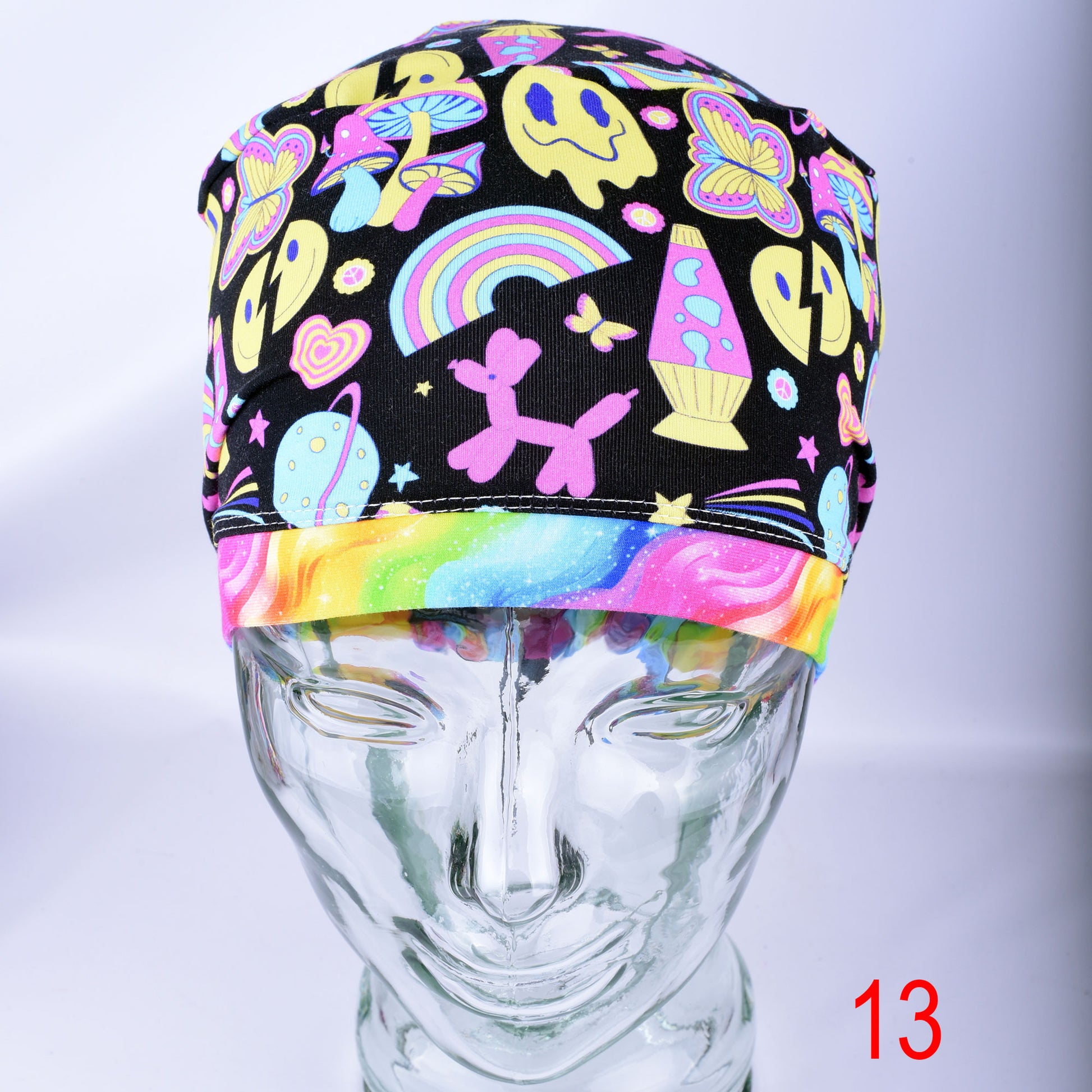 Front view of the Retro Days Full Coverage Scrub Cap on a clear mannequin head, showcasing the nostalgic 70s-inspired multicolor print and adjustable design.