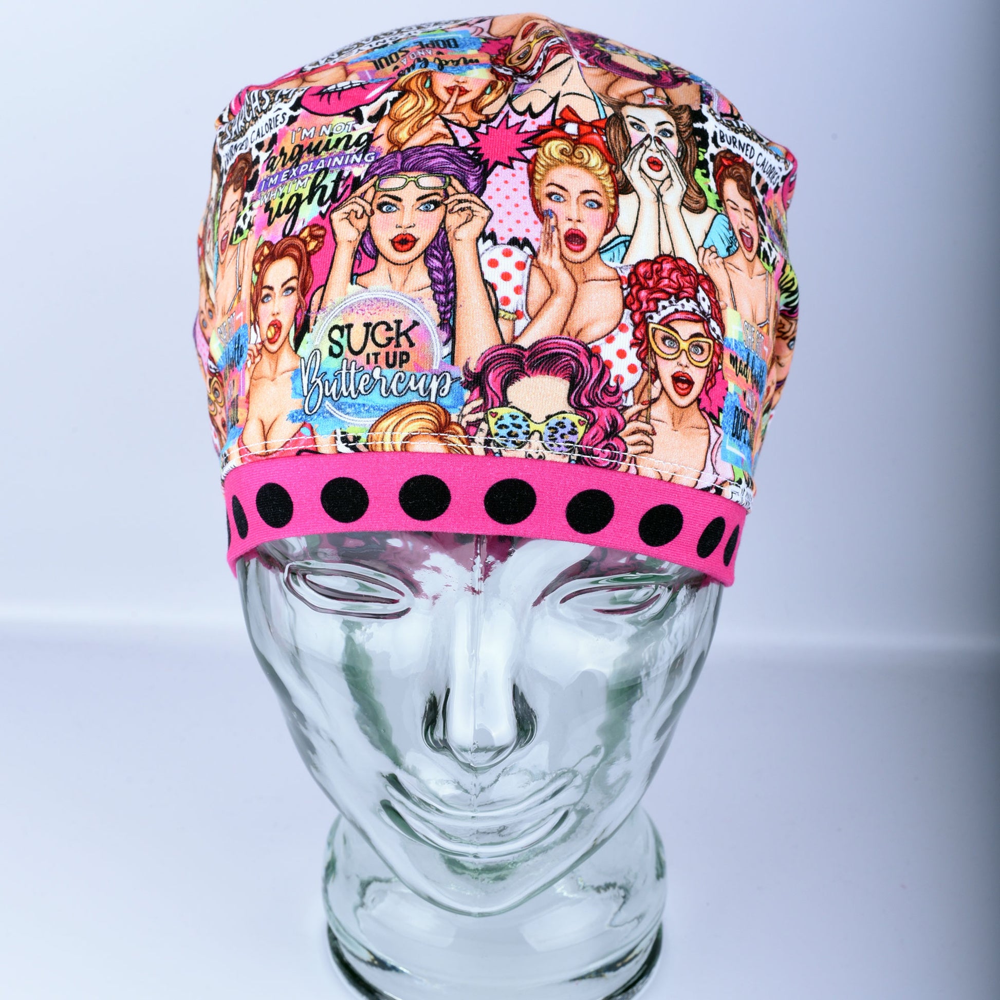 Front view of the Sassy Women scrub cap featuring retro women illustrations and vibrant polka dot pink brim detail.