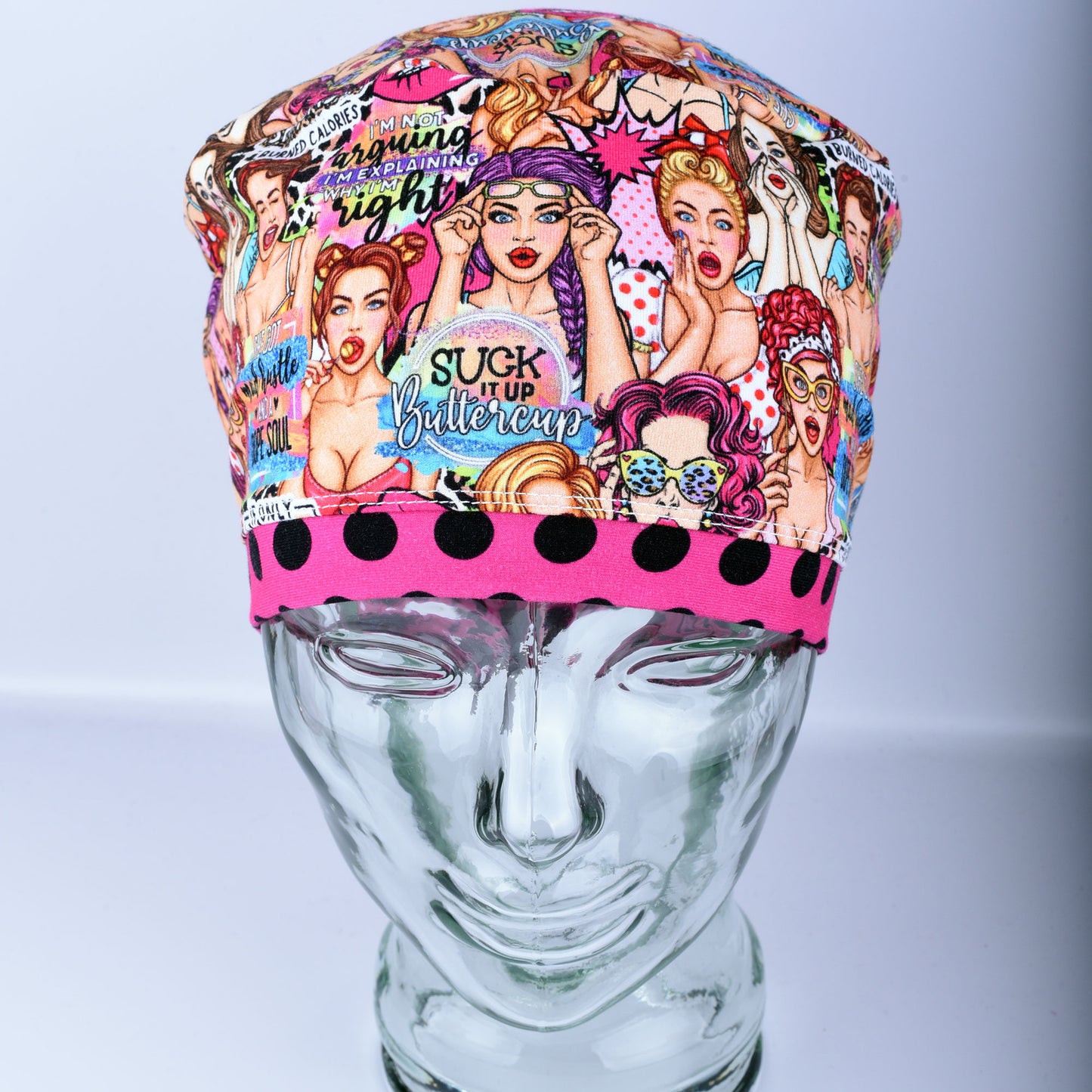 Front view of the Sassy Women scrub cap featuring retro women illustrations and vibrant polka dot pink brim detail.
