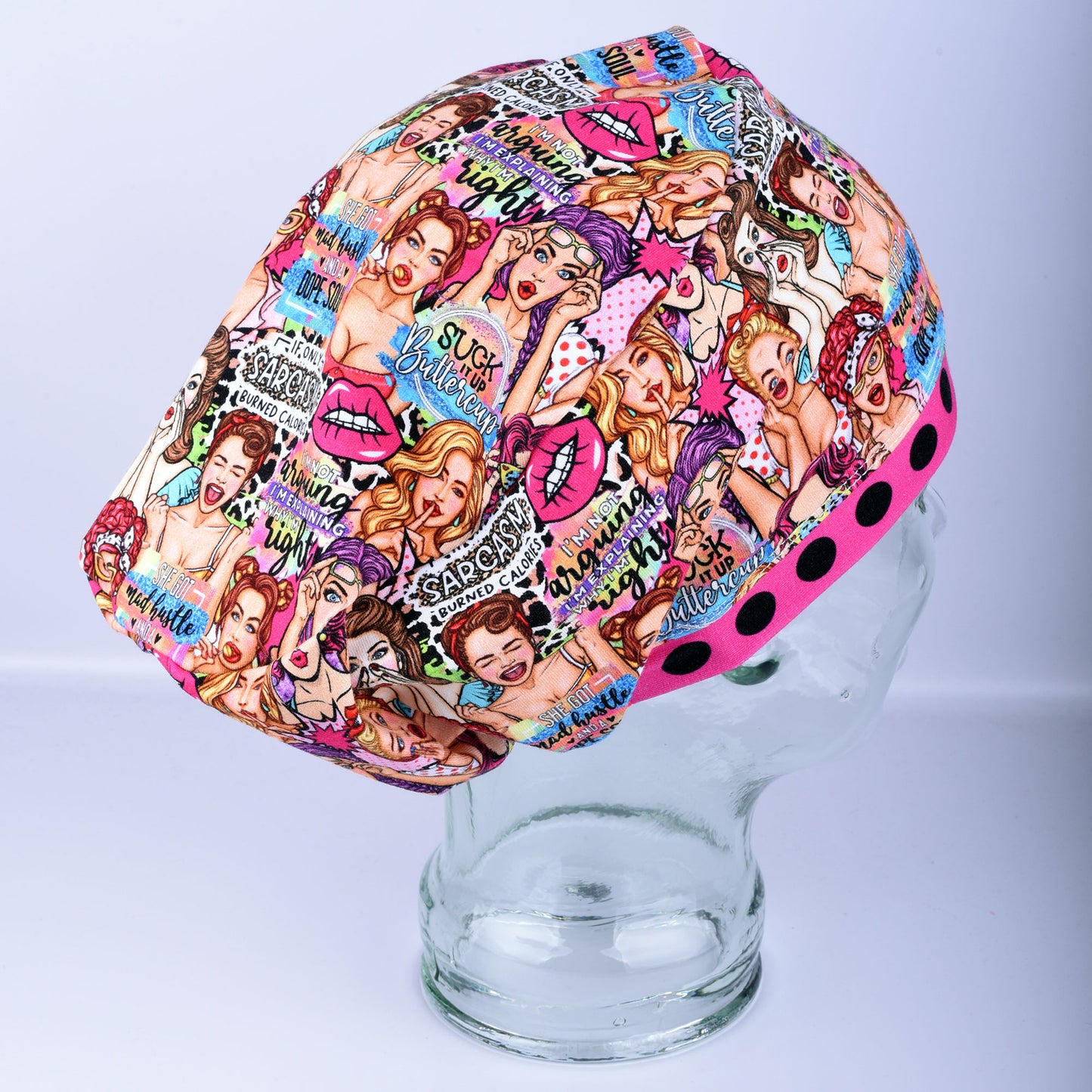 Three-quarter angle view of the Sassy Women scrub cap on a display head, showing full coverage fit and vintage-inspired print.