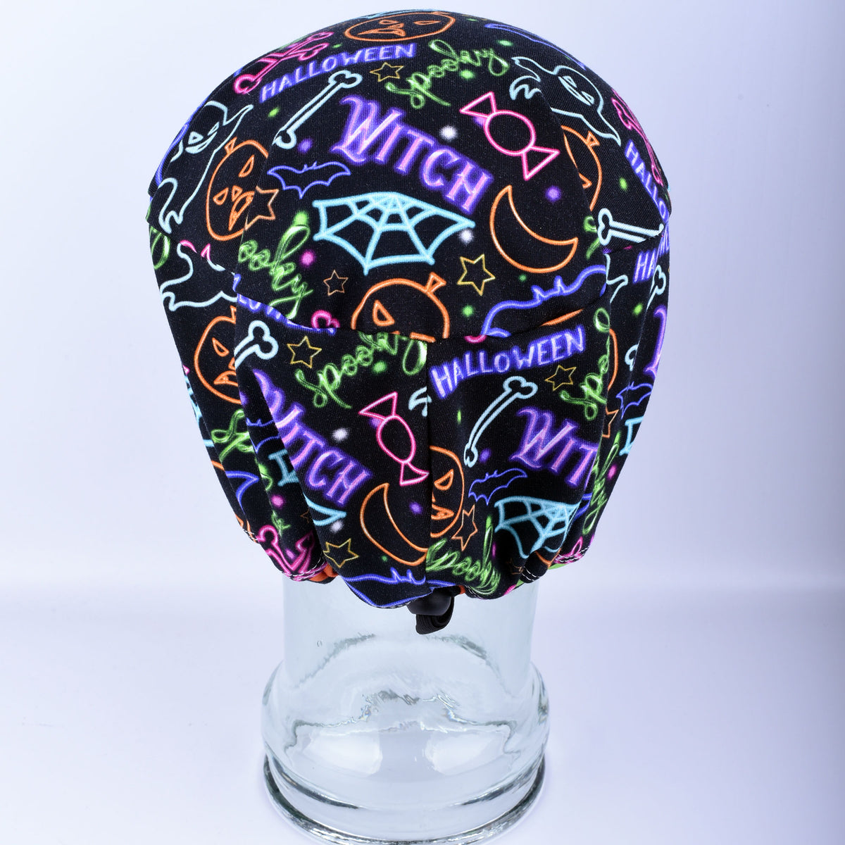 Back view of a medical scrub hat displaying the adjustable cord lock toggle and encased elastic closure.