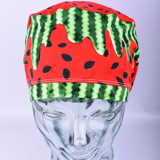 Full coverage watermelon print scrub cap featuring a vibrant red and green "drip" pattern on a white background, displayed on a mannequin head.