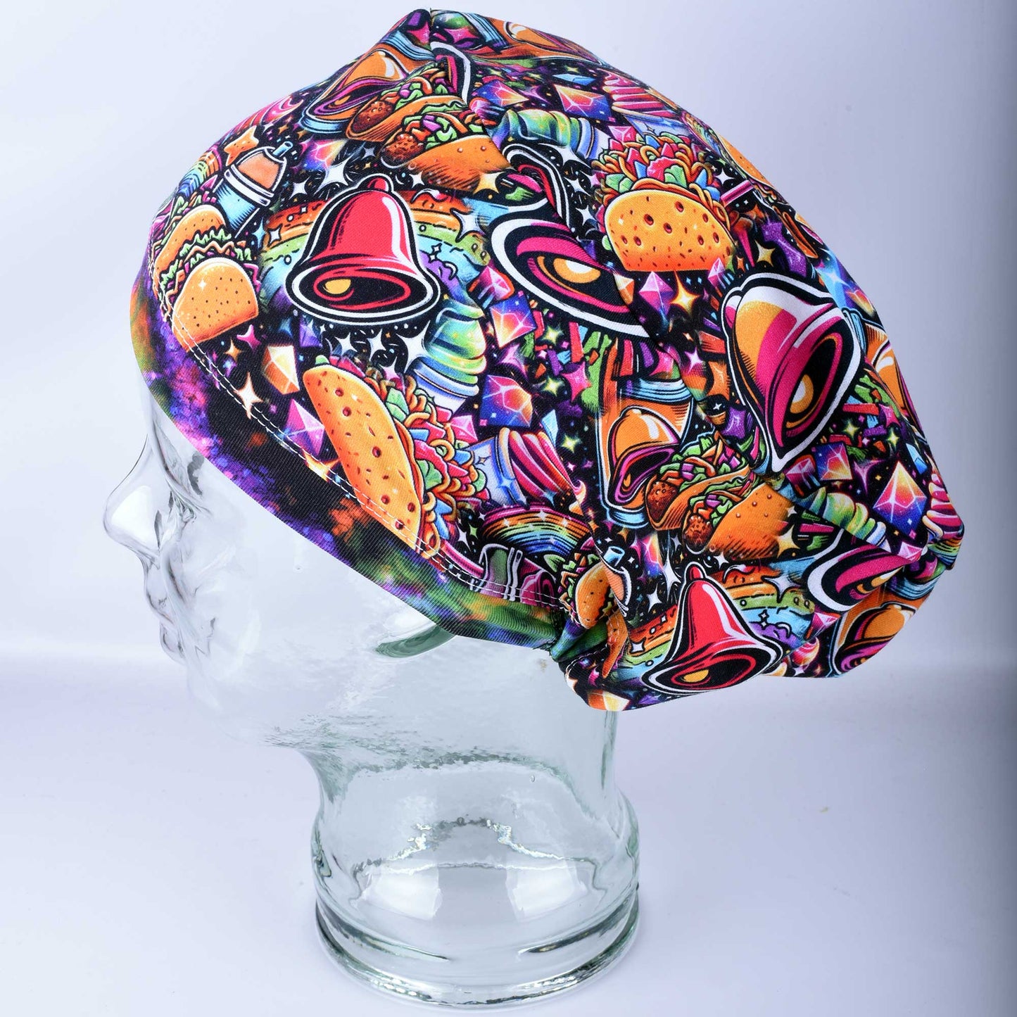 A Euro-style healthcare scrub cap featuring a colorful taco-themed print on a high-quality stretch knit fabric.