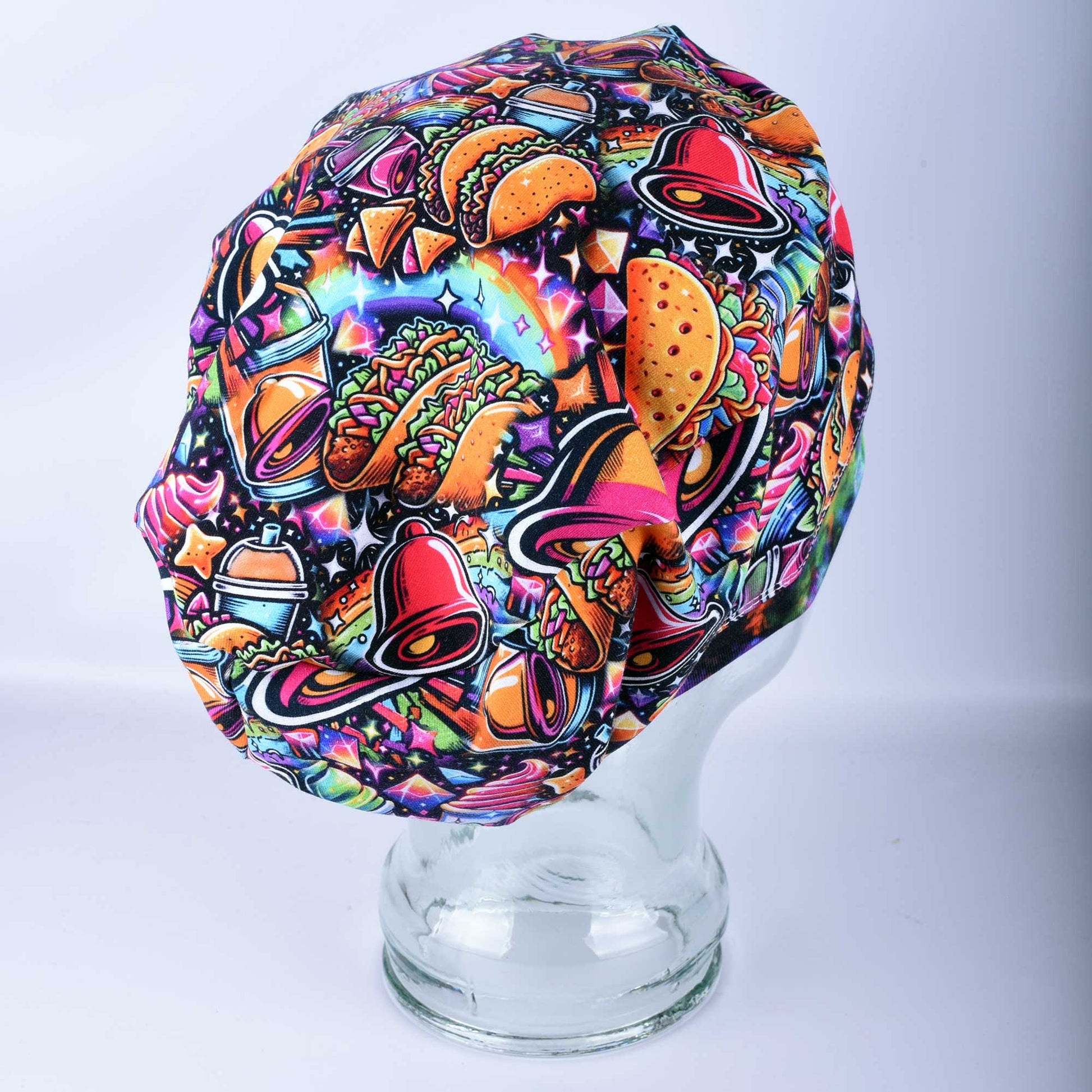 A Euro-style healthcare scrub cap featuring a colorful taco-themed print on a high-quality stretch knit fabric.