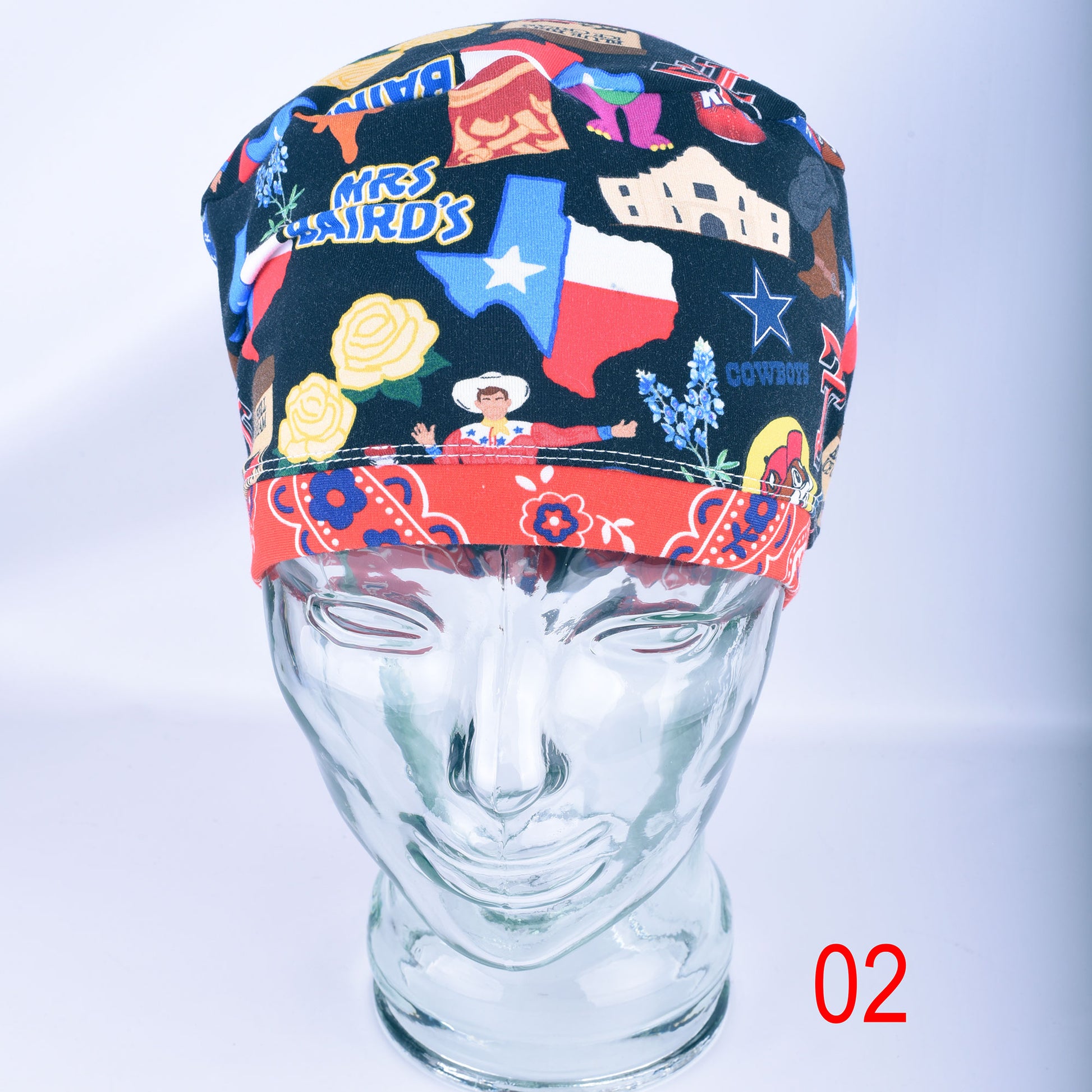 A multicolor cowboy-themed fabric head covering cap displayed on a clear glass mannequin head. The cap features a black background with a red bandana-style hem, decorated with illustrations of the Texas state, a cowboy, and roses.