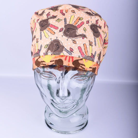 Colorful Thanksgiving patterned cap on a glass mannequin head against a light background