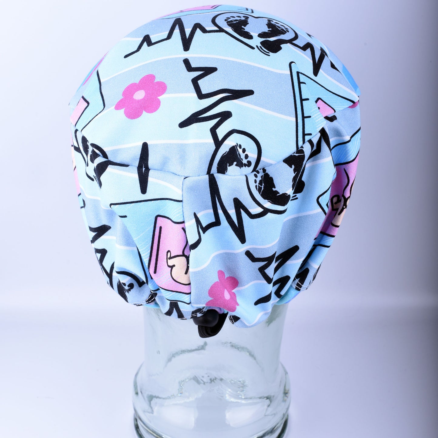 Close-up of the adjustable cord lock toggle and elastic back on a handmade sonographer scrub hat.