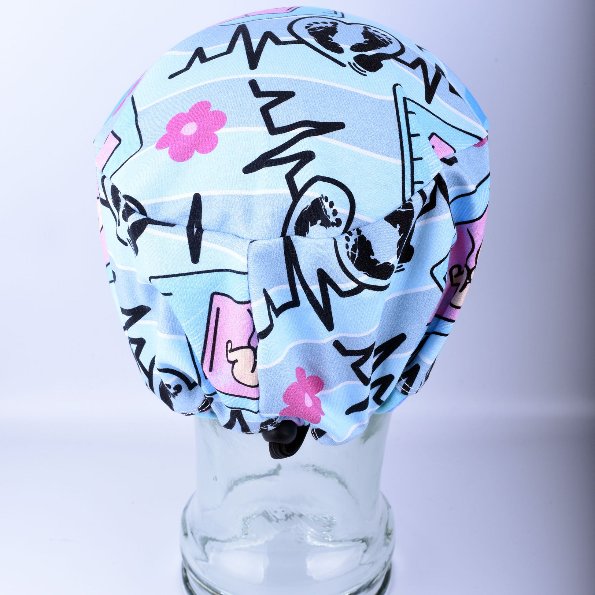 Close-up of the adjustable cord lock toggle and elastic back on a handmade sonographer scrub hat.