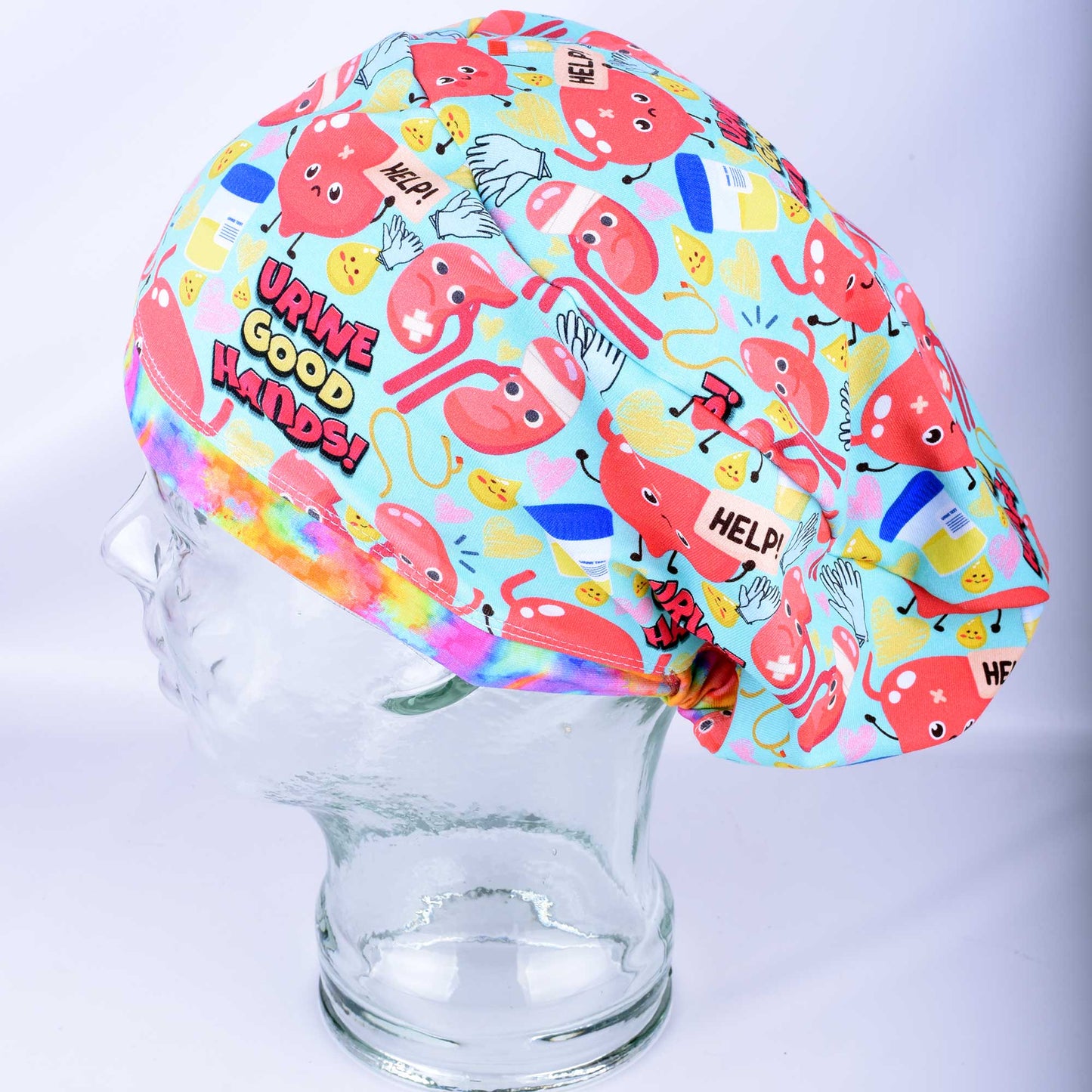 Side view of Urine Good Hands urology nephrology scrub cap on mannequin showing colorful medical print and full coverage fit.