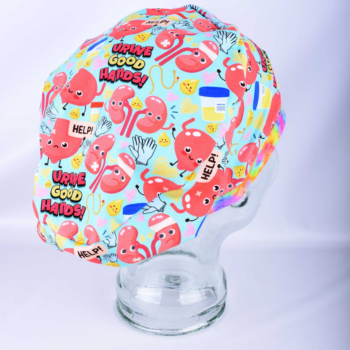 Side view of Urine Good Hands urology nephrology scrub cap on mannequin showing colorful medical print and full coverage fit