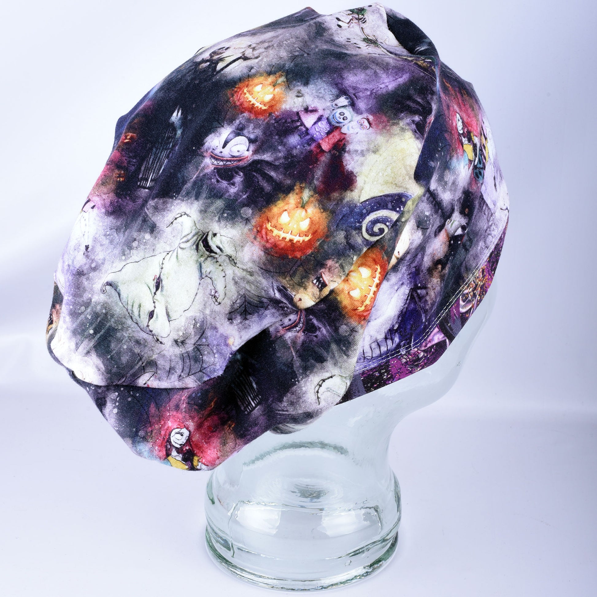 Side profile of a breathable, stretchy cotton-blend Halloween scrub cap worn on a mannequin head, highlighting full hair coverage and seamless fabric fit.